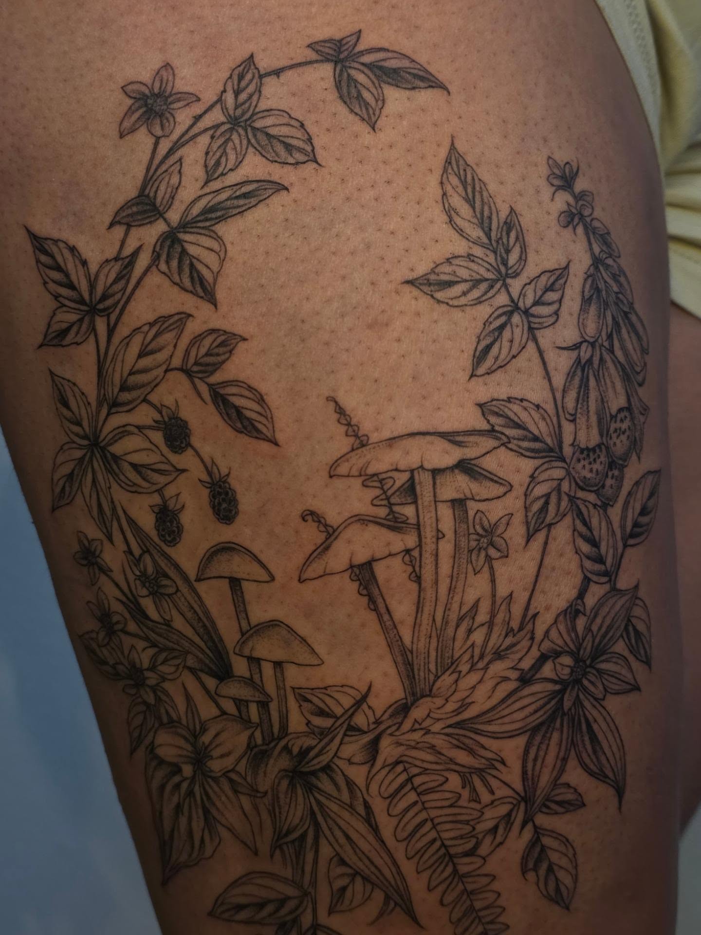 Forest flora realism tattoo on the thigh by Sierra (cc) Klein