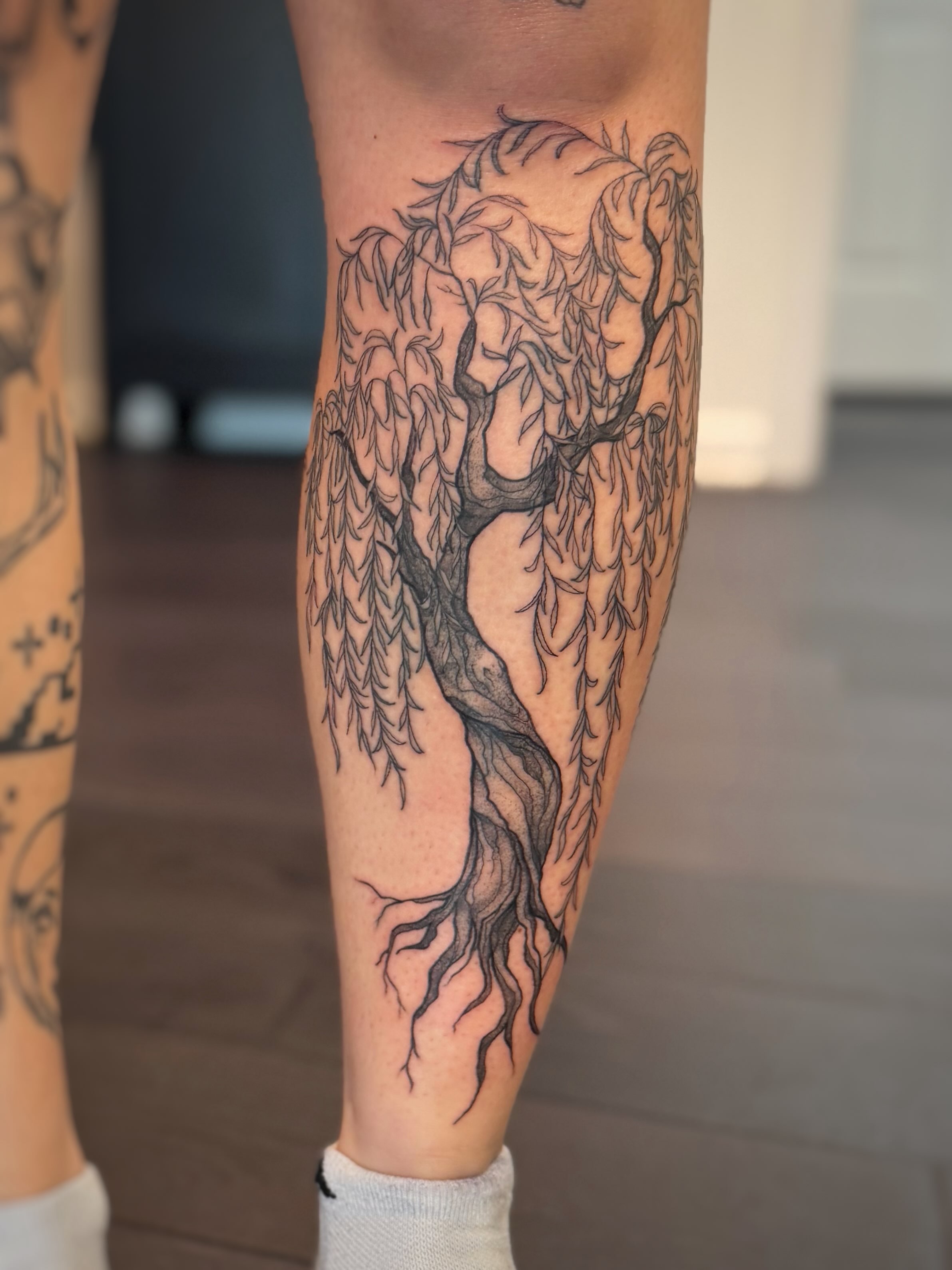 Weeping willow black and grey tattoo on the calf by Kori Millhimes