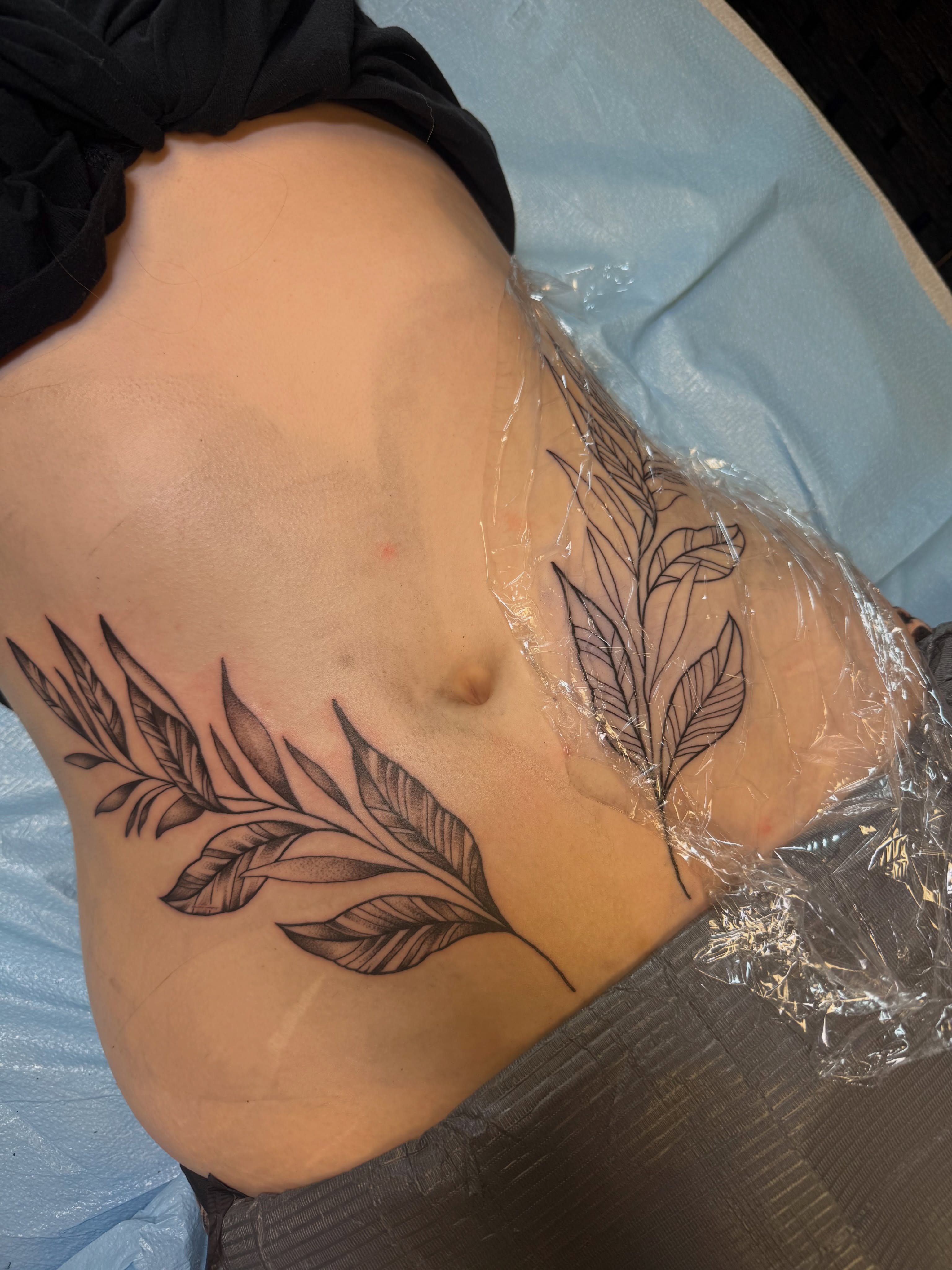 Feather black and grey tattoo on the ribs by Exploitedtattoos