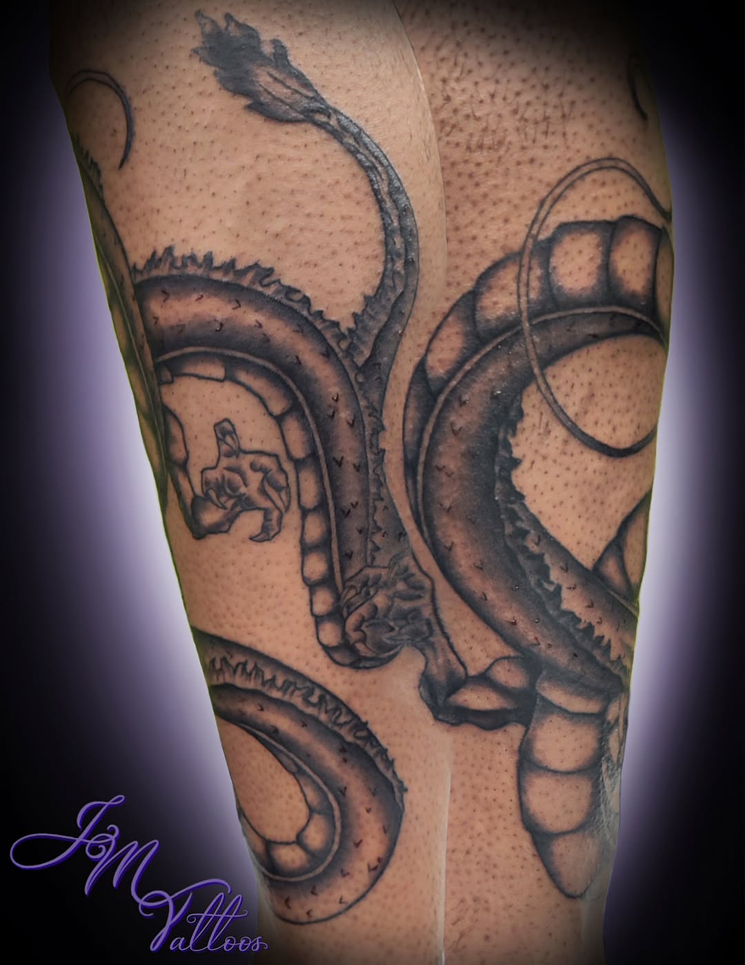Serpent black and grey tattoo on the forearm by Julie MacDonald
