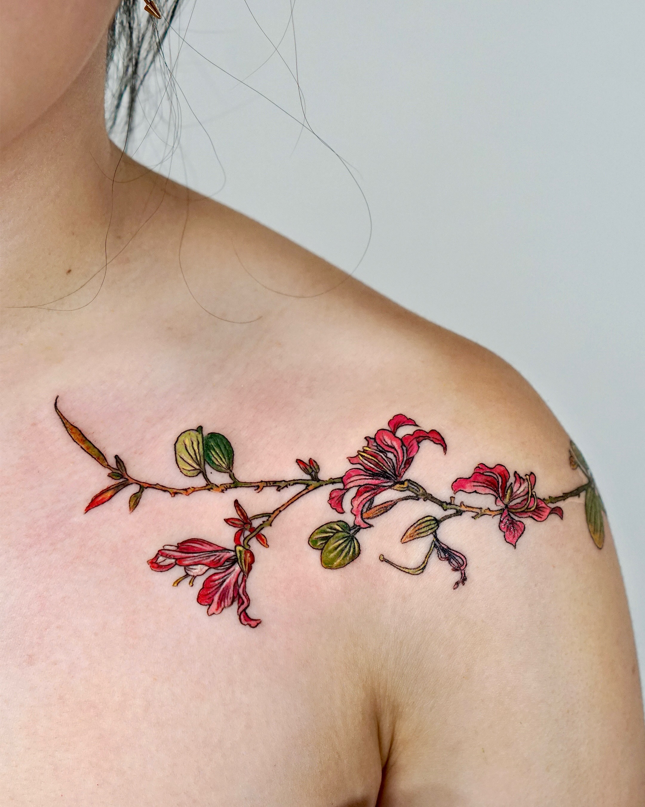 Flower branch realism tattoo on the shoulder by Isle