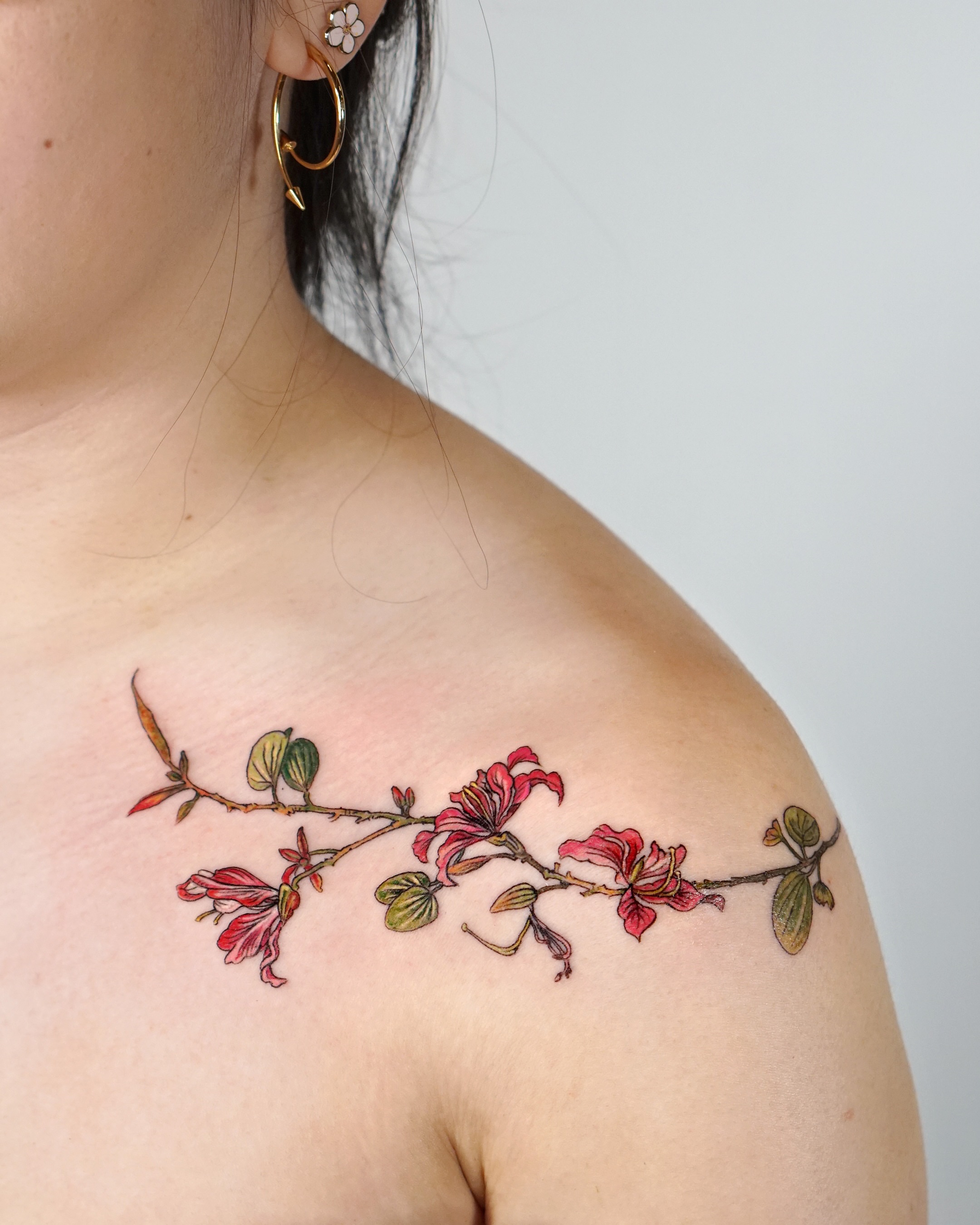 Flower branch realism tattoo on the shoulder by Isle
