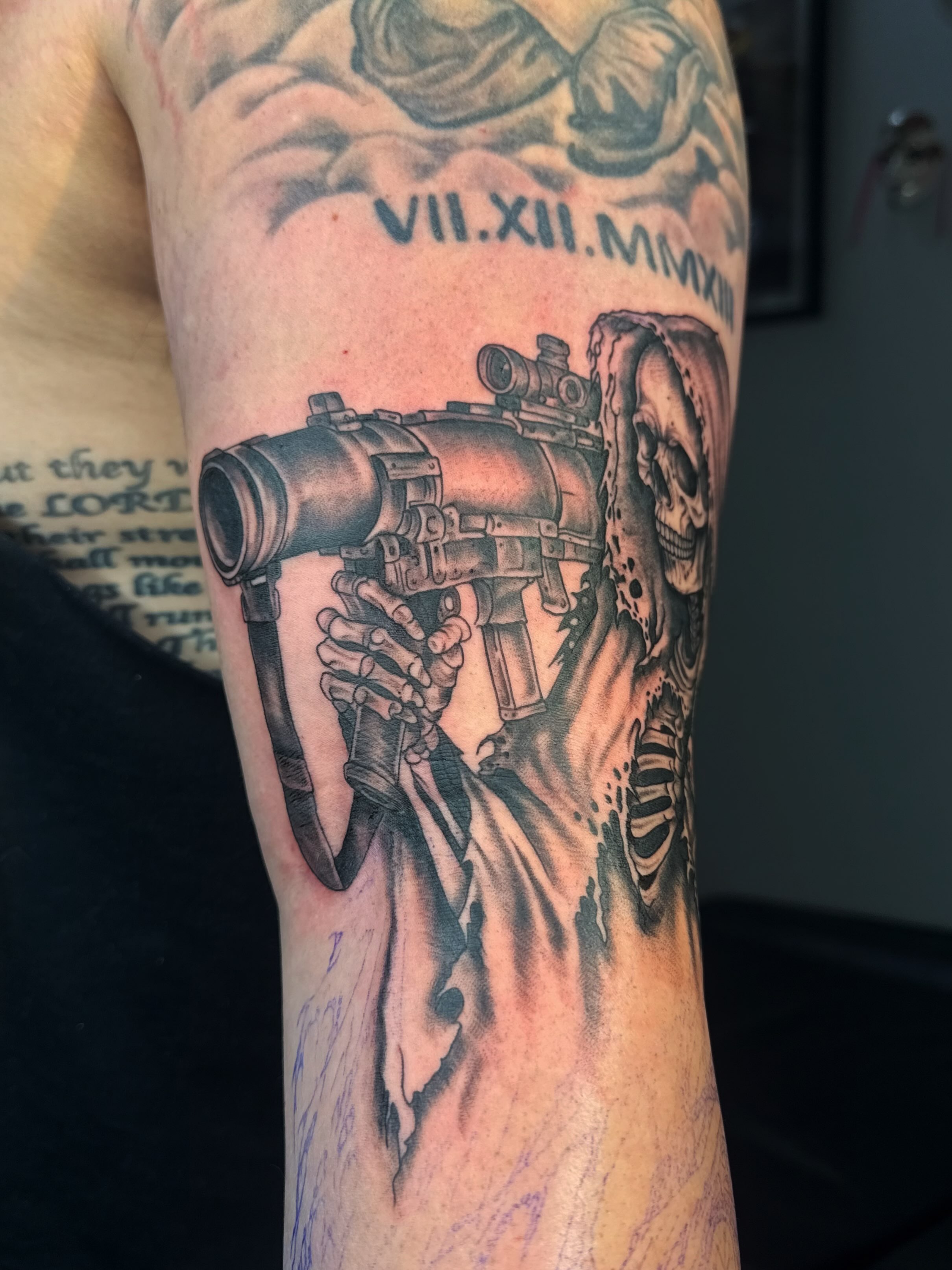 Machine gun and skeleton realism tattoo on the forearm by Imani
