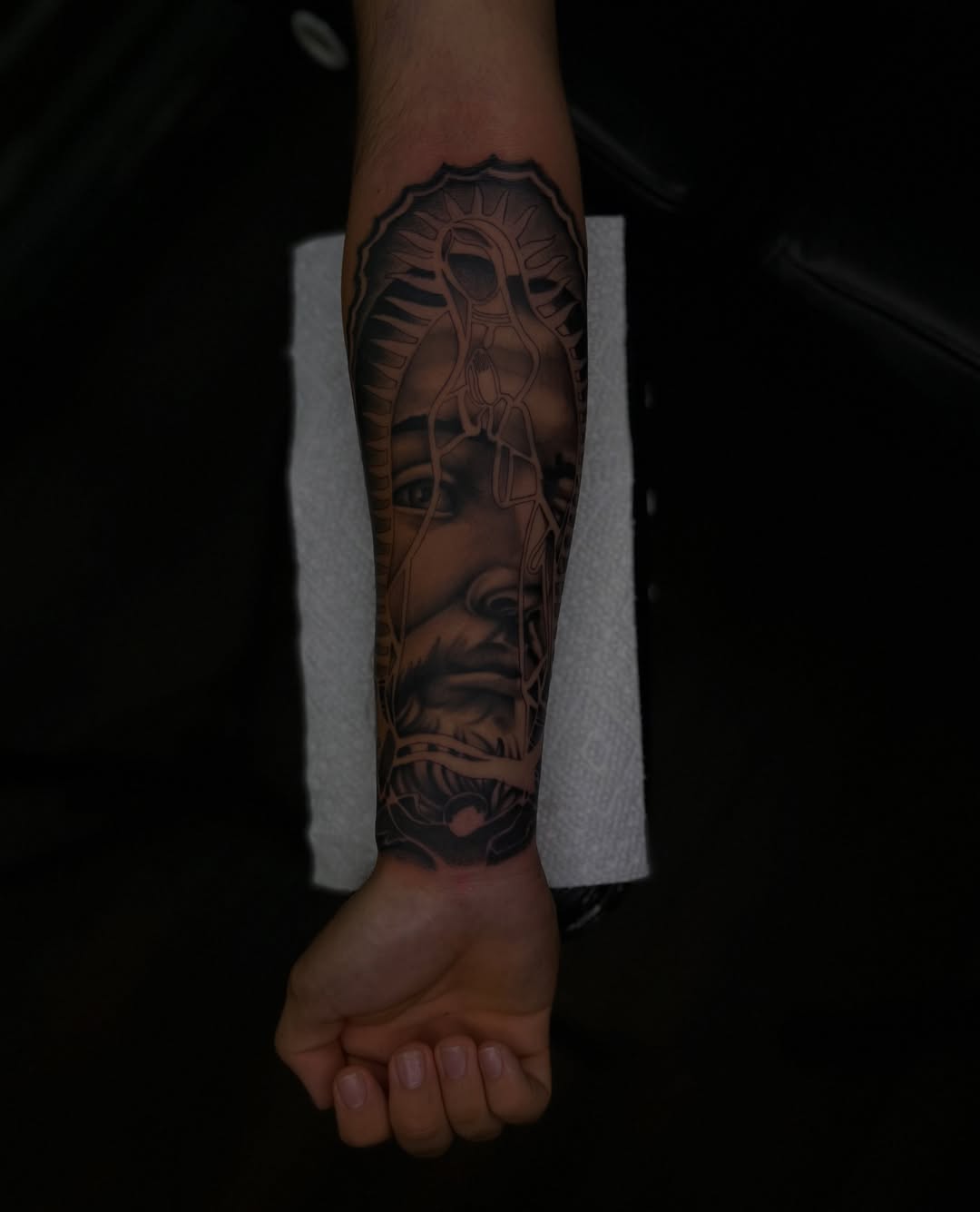 Man's face realism tattoo on the forearm by Tattoo Artist
