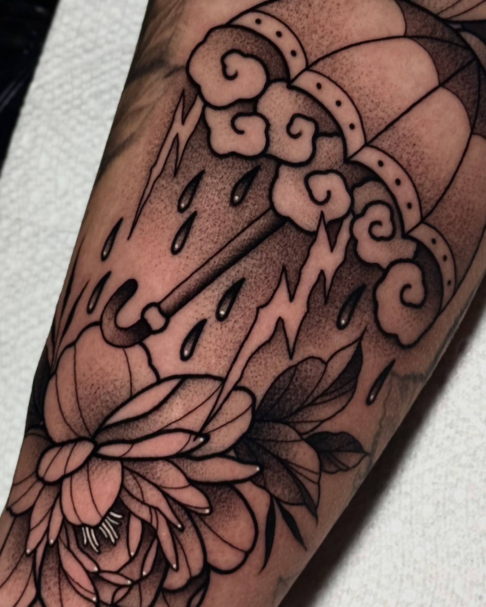 Rainbow and flower dotwork tattoo on the forearm by Bell Bolton
