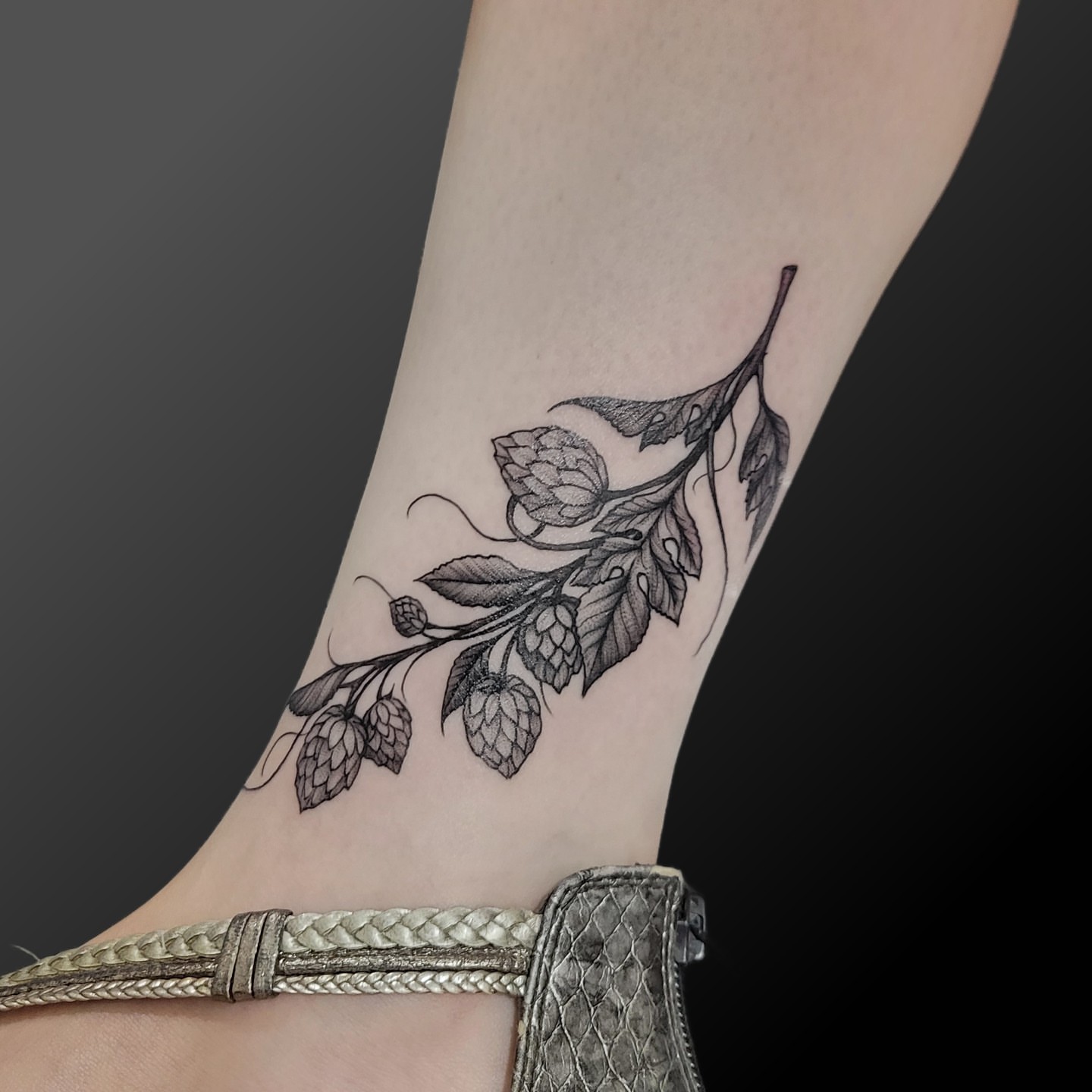 Hop branch black and grey tattoo on the forearm by Arick Reese