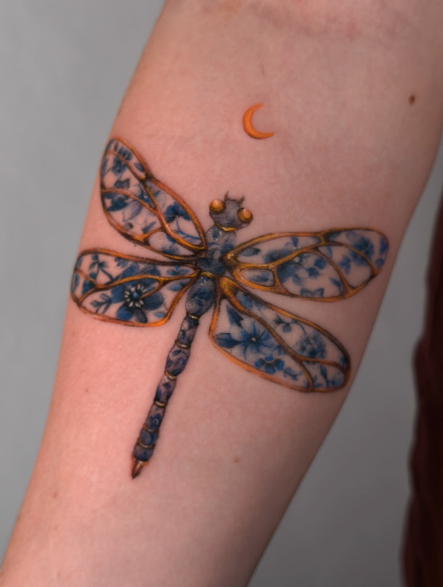 Dragonfly realism tattoo on the forearm by Vince Lau
