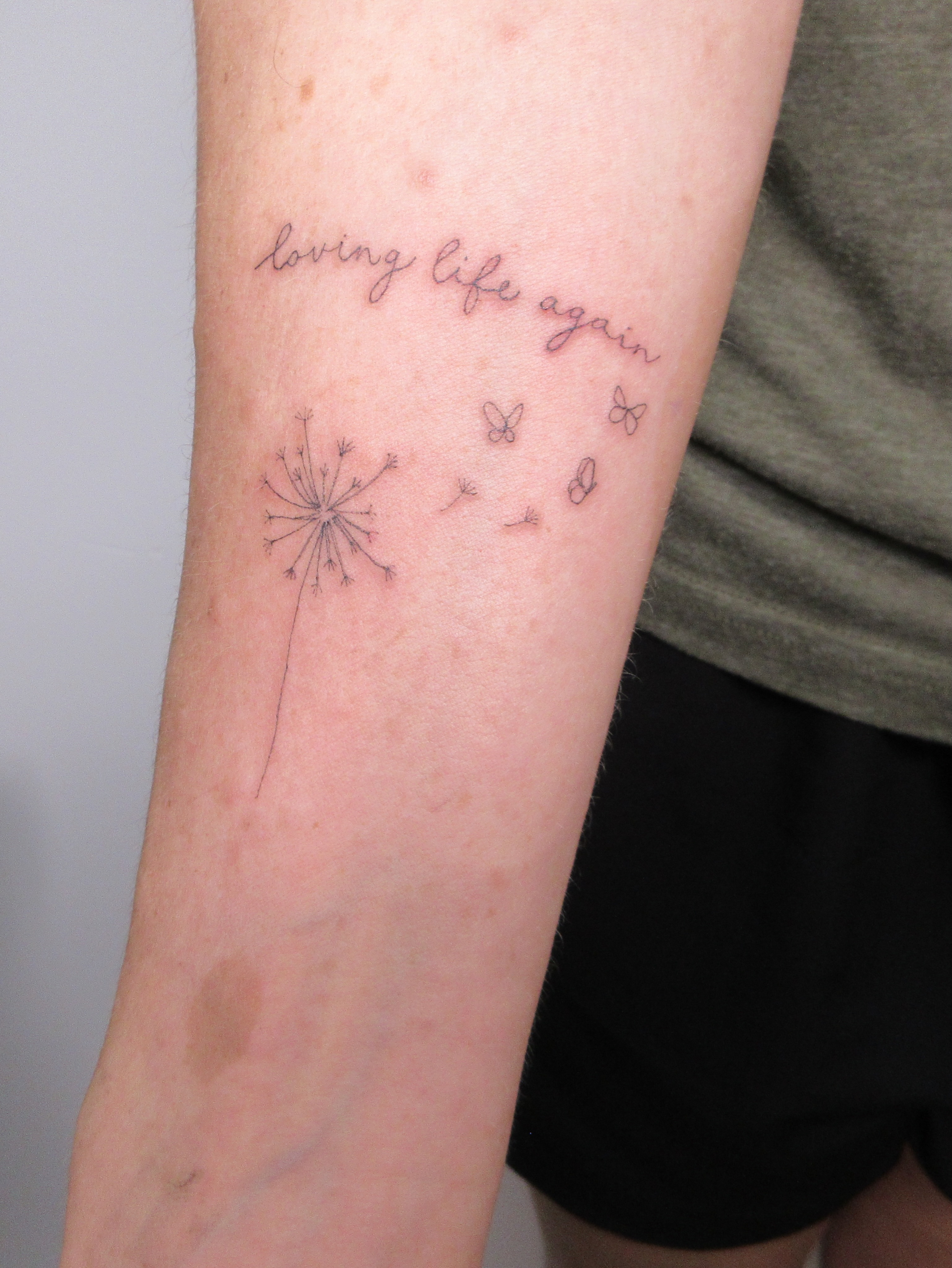 Dandelion seeds fine line tattoo on the forearm by Nicole