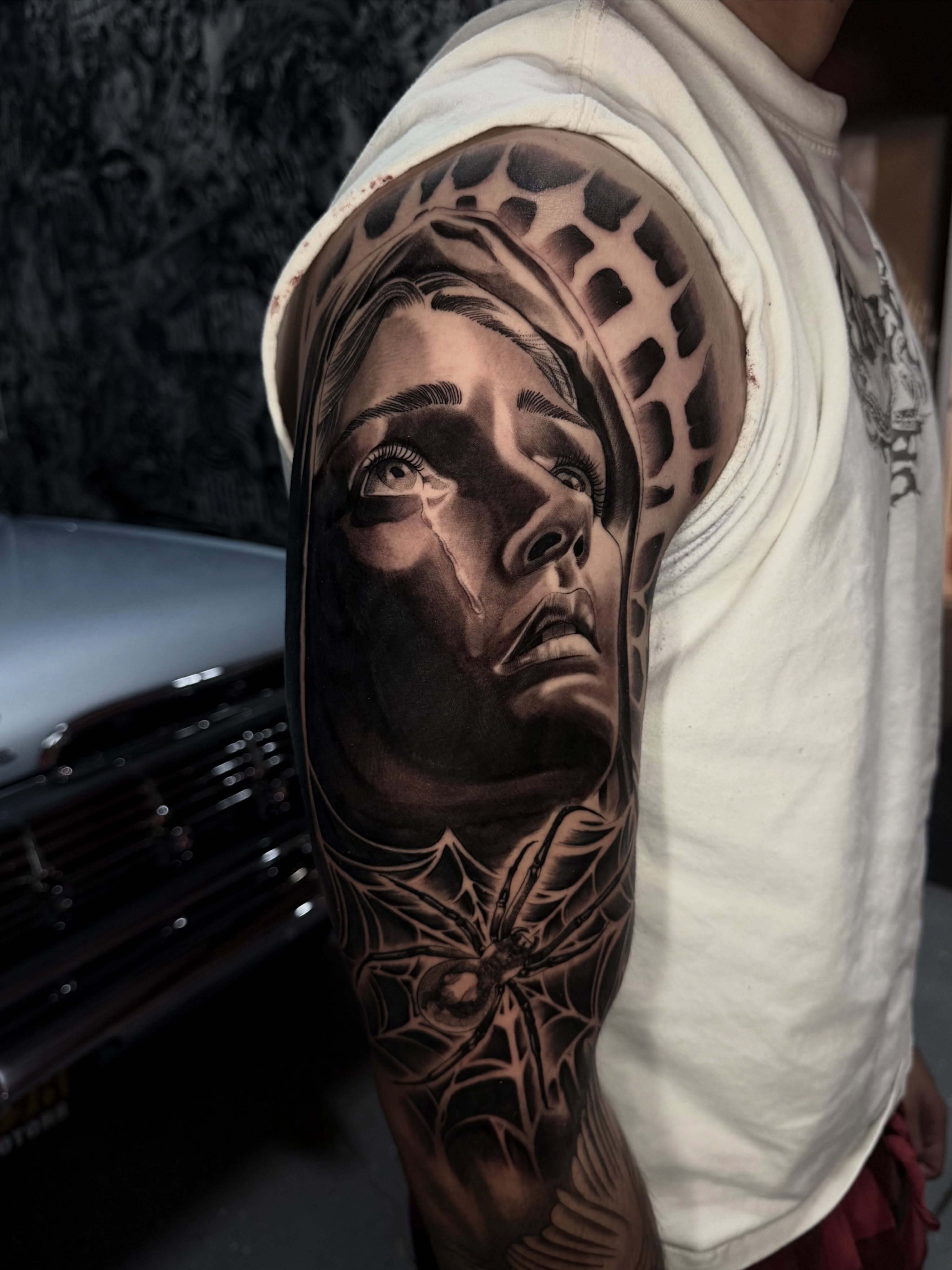 Woman's face realism tattoo on the upper arm by San Diego Tattoo Artist