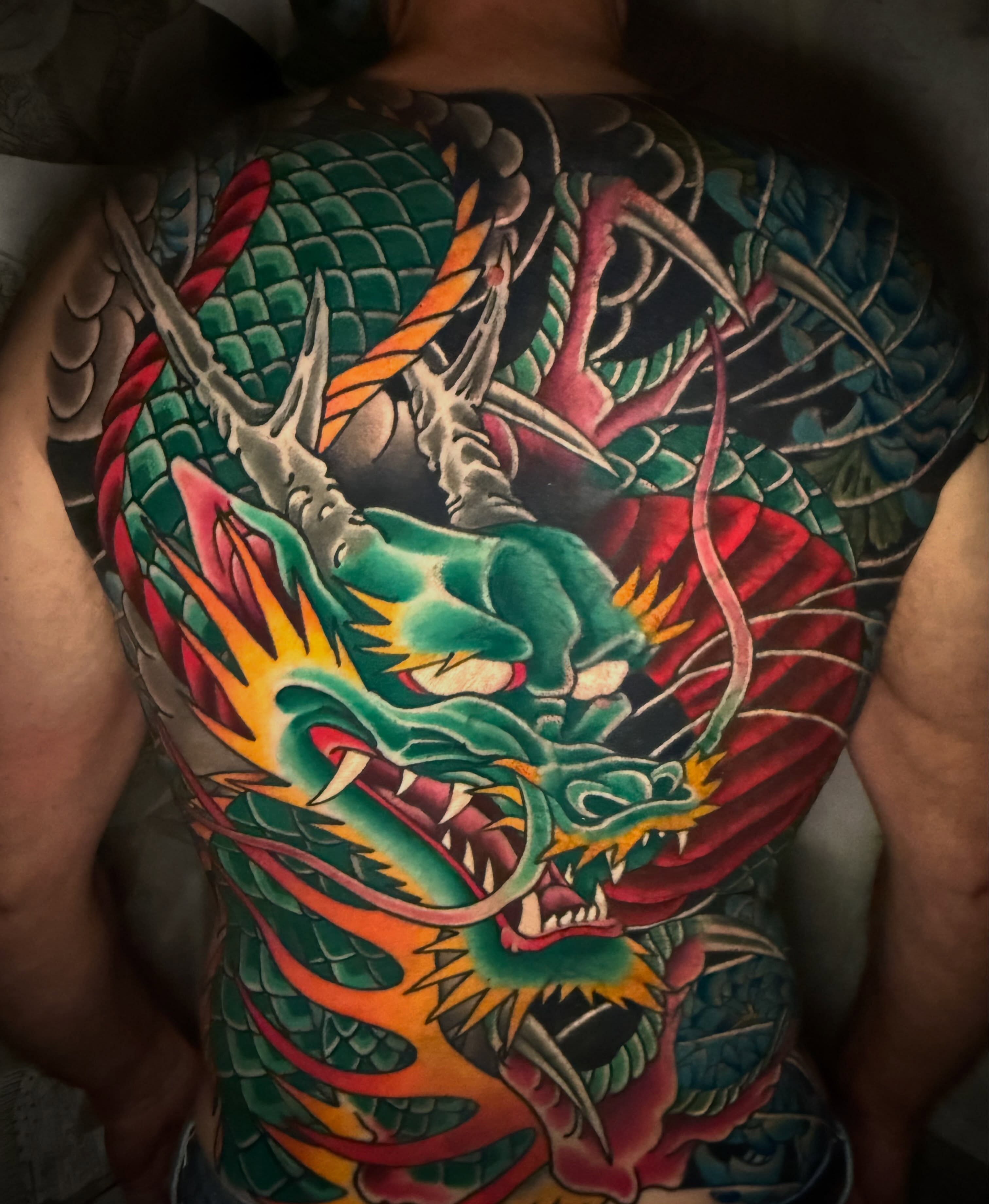 Dragon American traditional tattoo on the chest by Mike Diamond