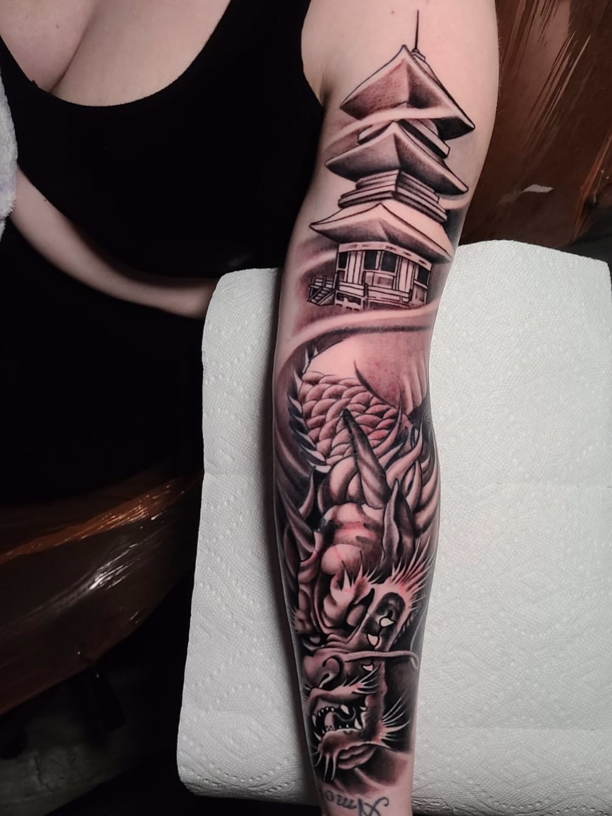 Dragon and pagoda realism tattoo on the forearm by Exis LHinc, Miami, Florida