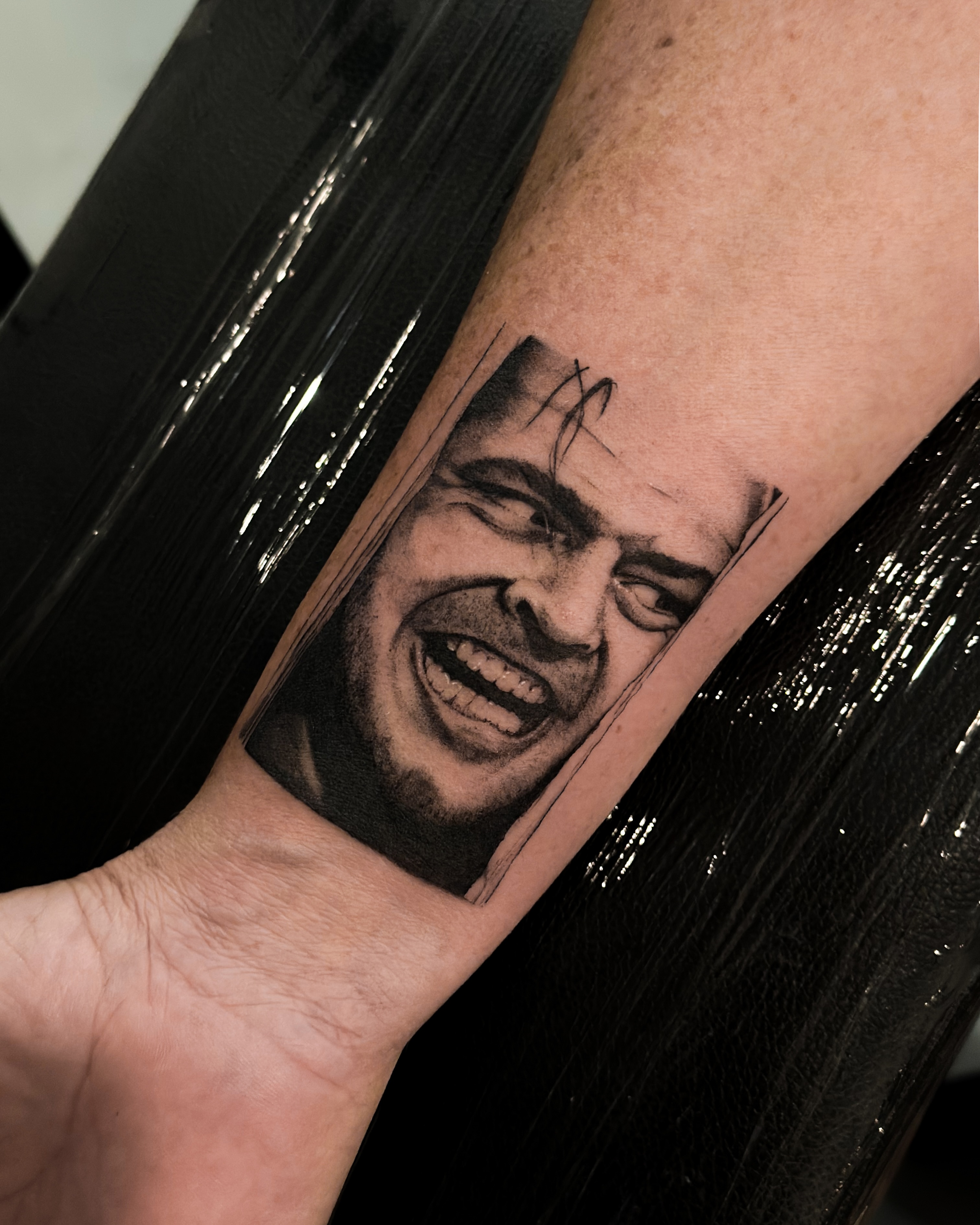 Man's face realism tattoo on the forearm by Lauren