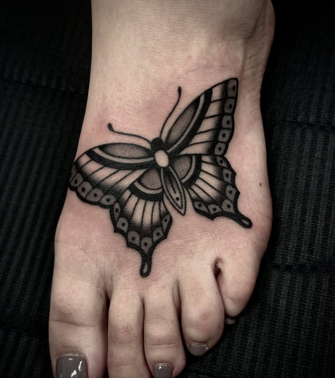 Butterfly black and grey tattoo on the foot by Ally noel