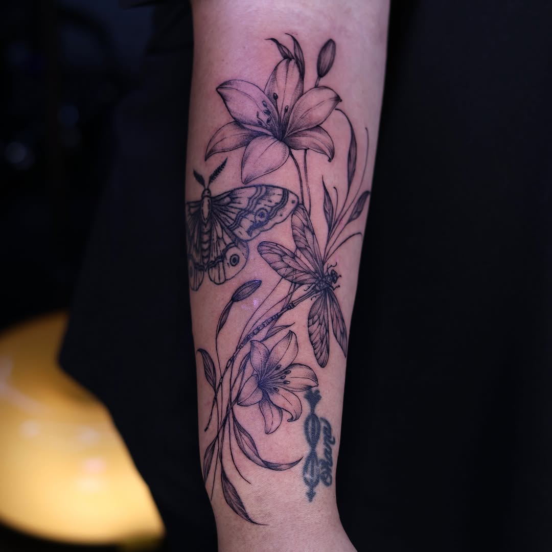 Lilies and butterflies realism tattoo on the forearm by Tetiana
