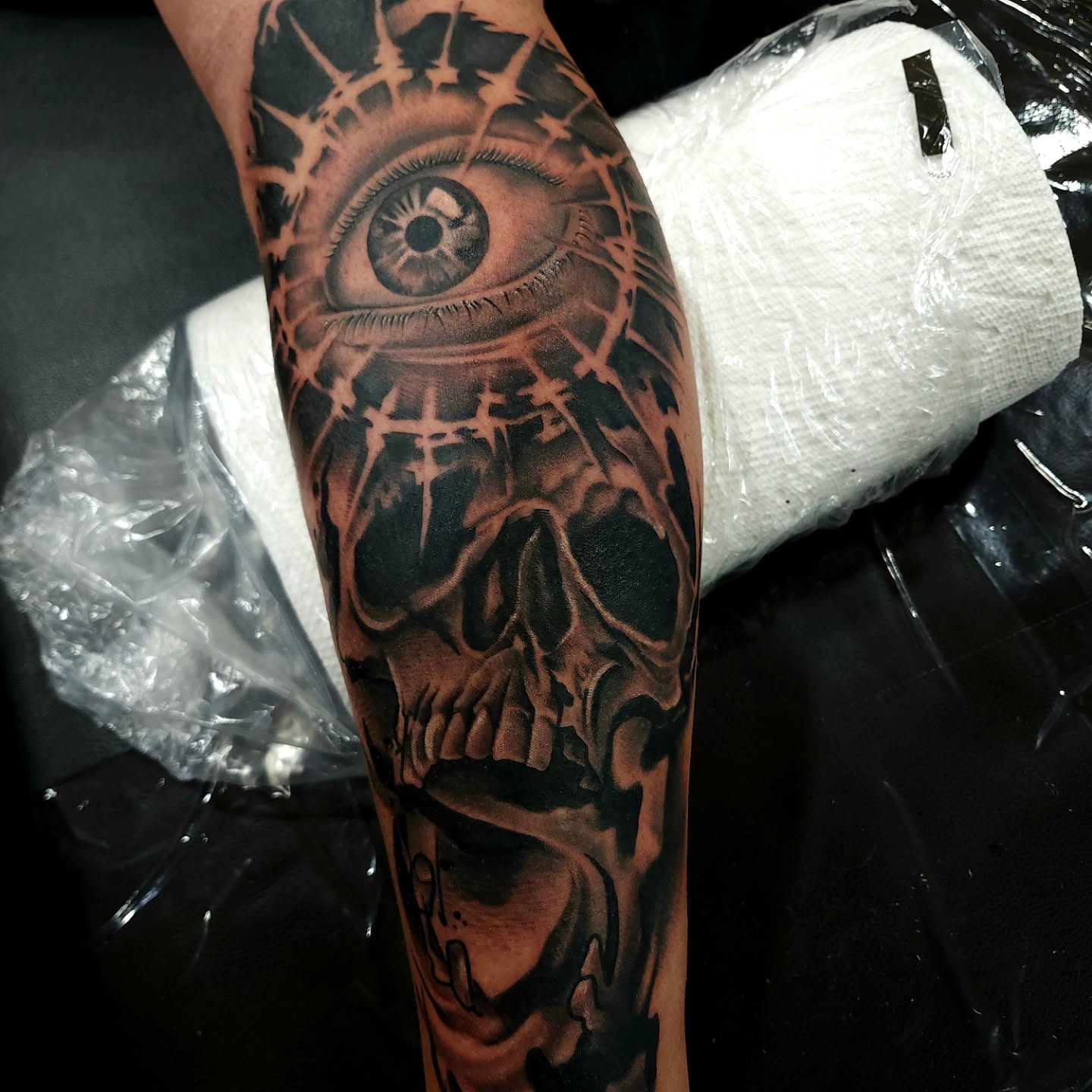 Eye and skull realism tattoo on the forearm by Chris Wodarski