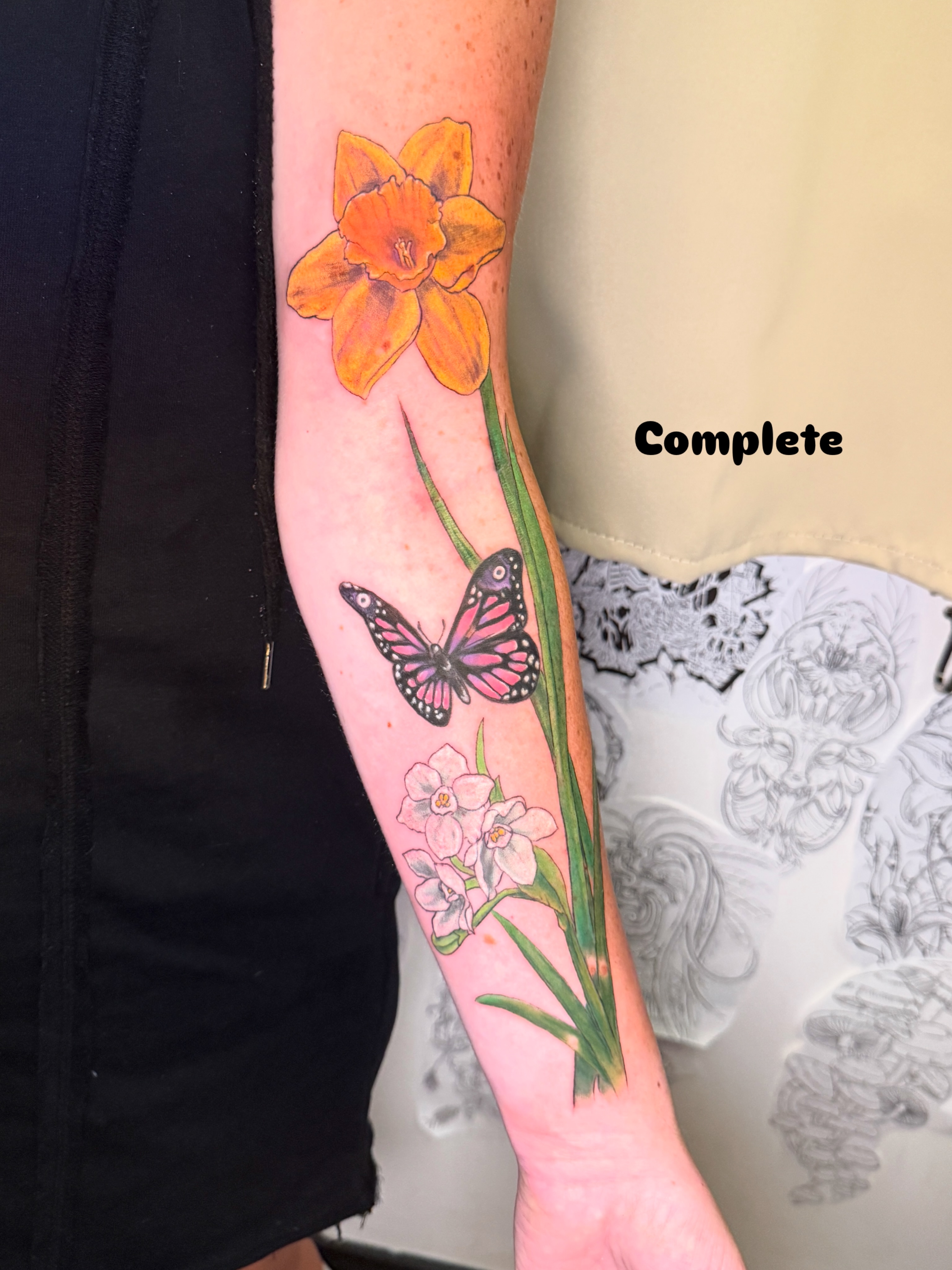 Daffodil and butterfly realism tattoo on the forearm by ❈°binx°❈