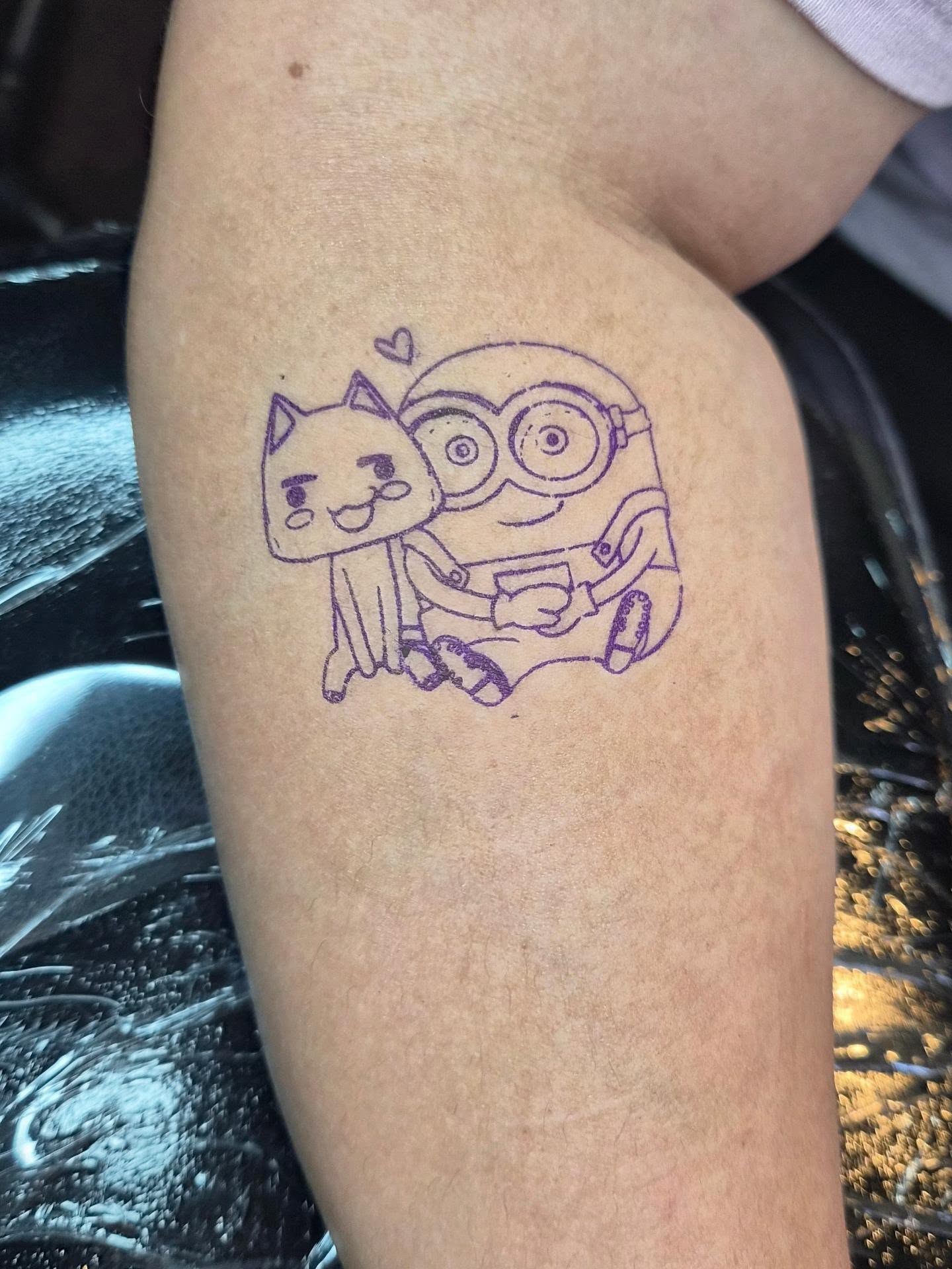 Cat and minion illustrative tattoo on the thigh by Cielle