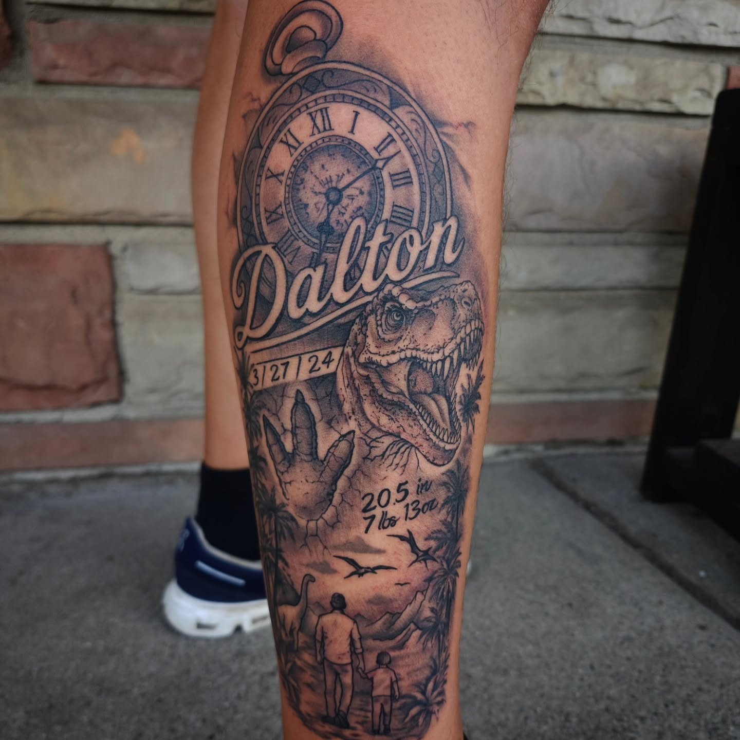 Dinosaur and family realism tattoo on the forearm by Chris Wodarski