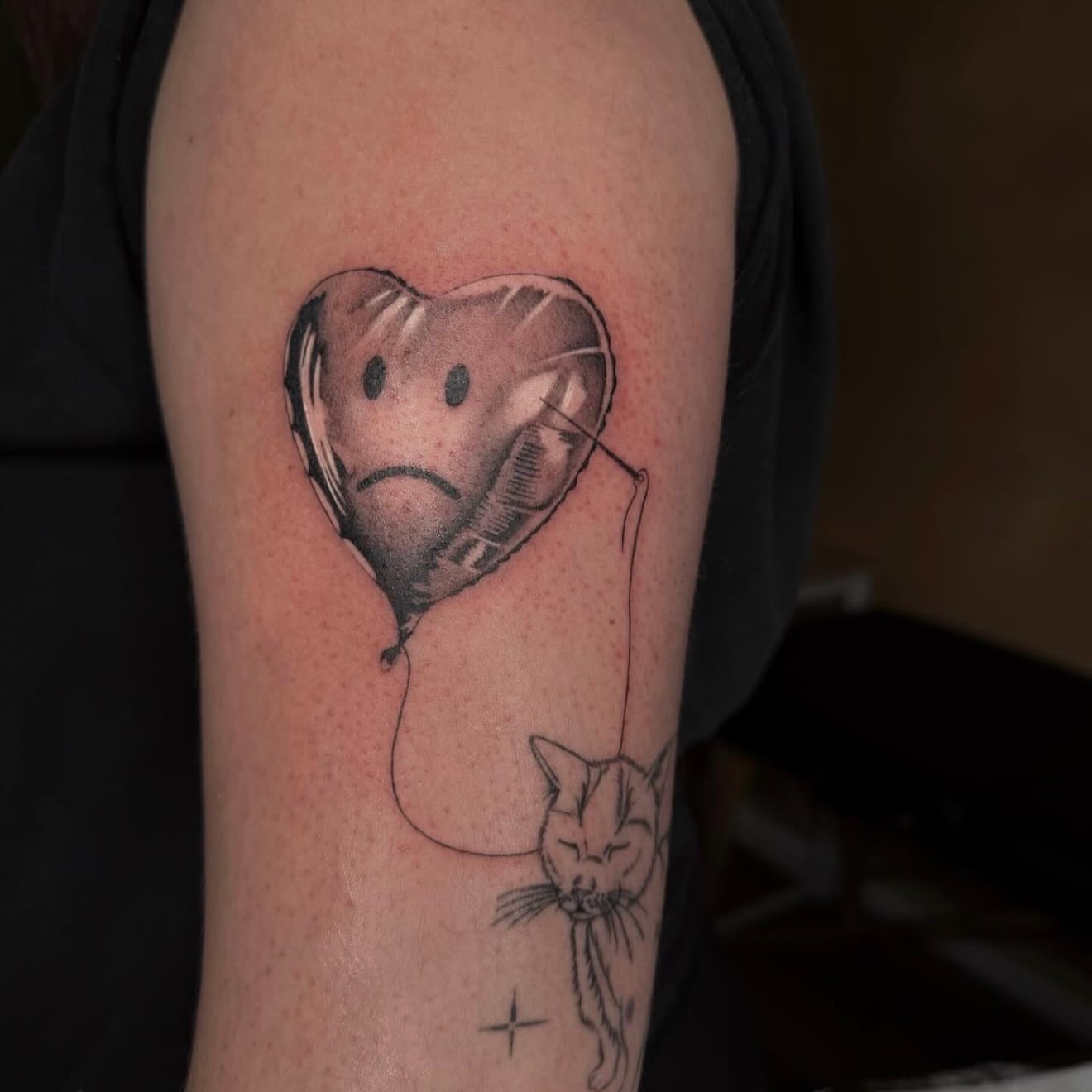 Sad balloon with cat realism tattoo on the forearm by Jas Knight