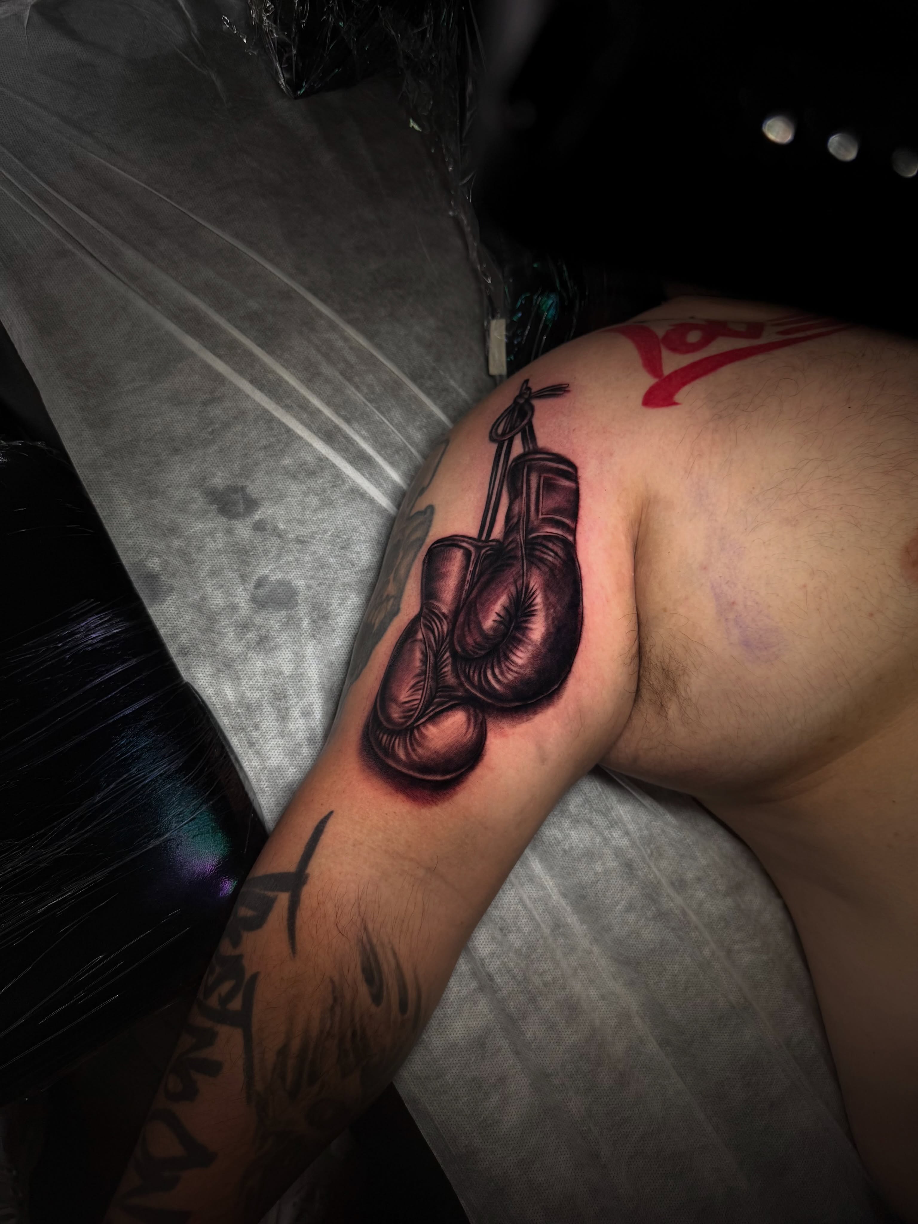 Boxing gloves realism tattoo on the shoulder by Nj Tattoo Artist Inkdyou, Bloomfield, New Jersey