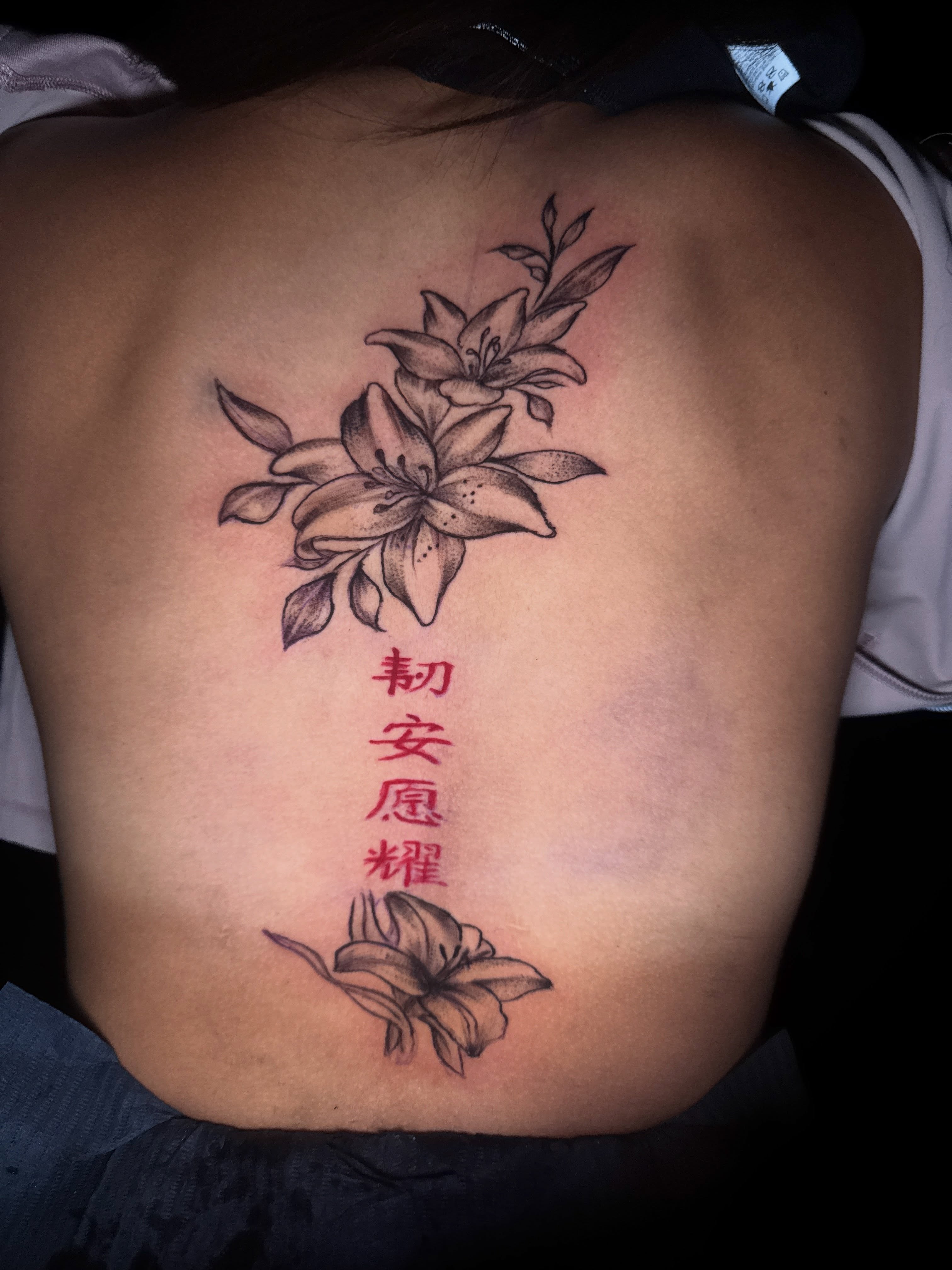 Lilies and Chinese characters black and grey tattoo on the back by dallas tattoo artist, Duncanville, Texas