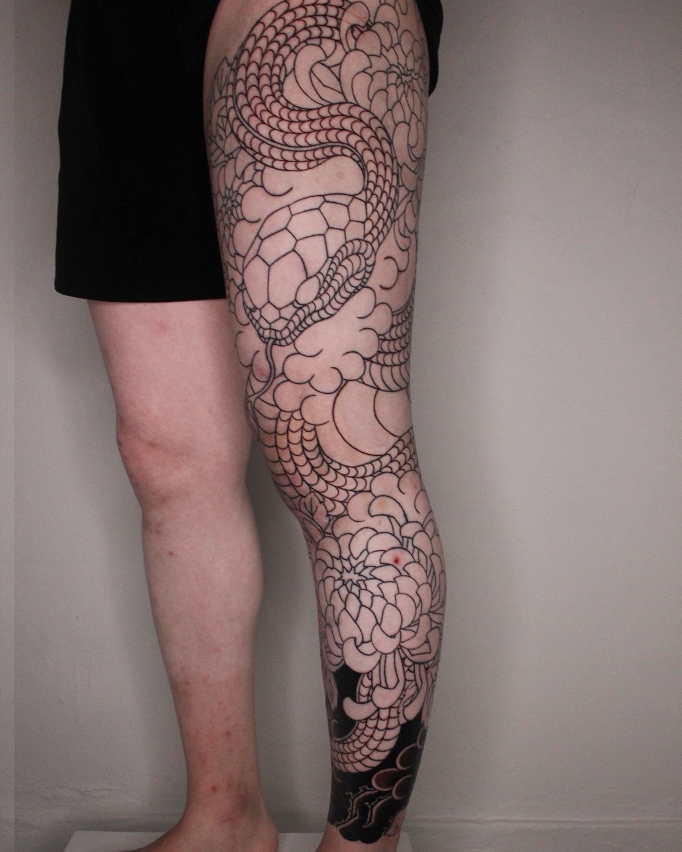 Snake and peony black and grey tattoo on the calf by 건대이레즈미