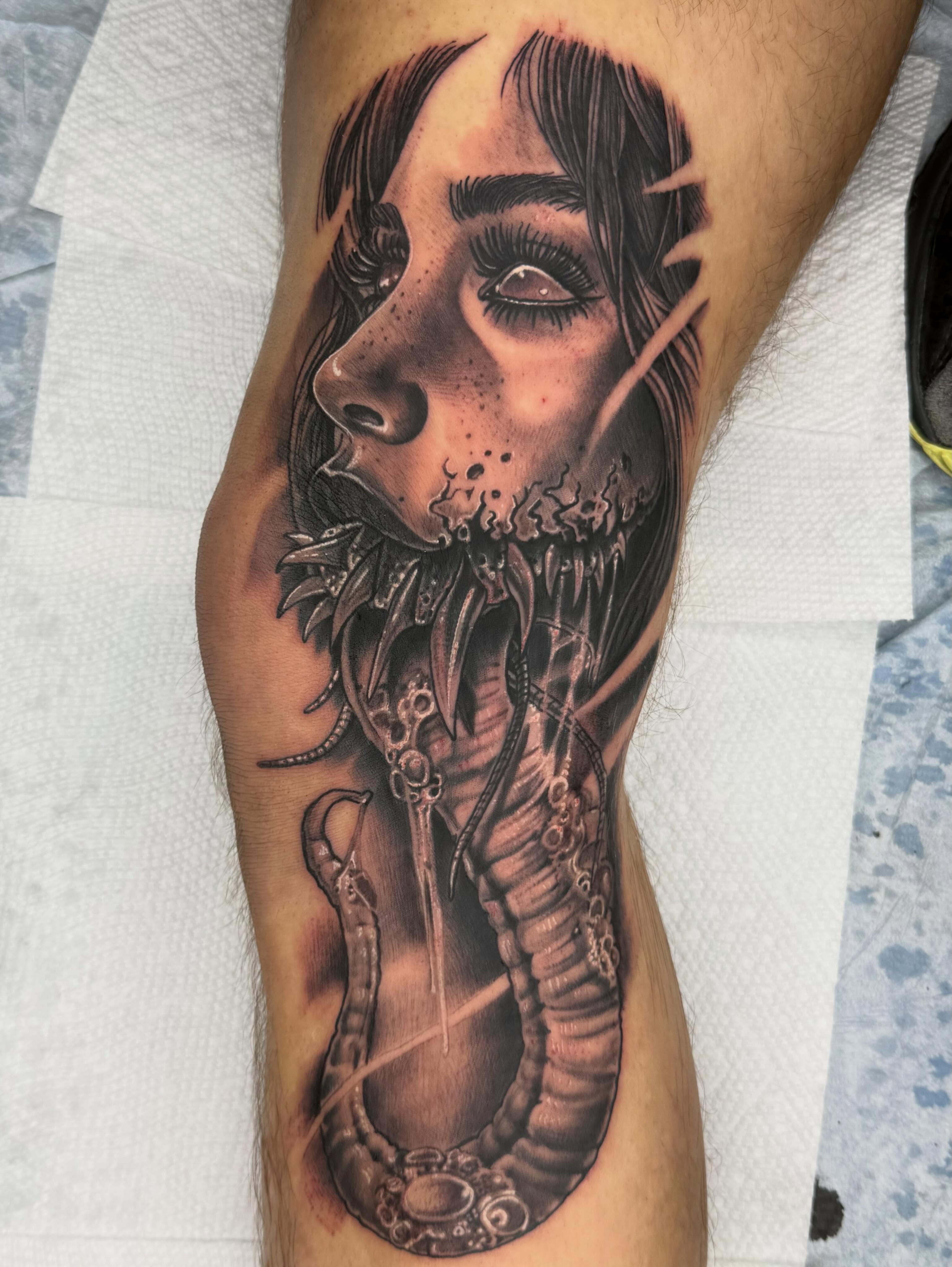 Woman with snake dark realism tattoo on the forearm by Frank DeMao