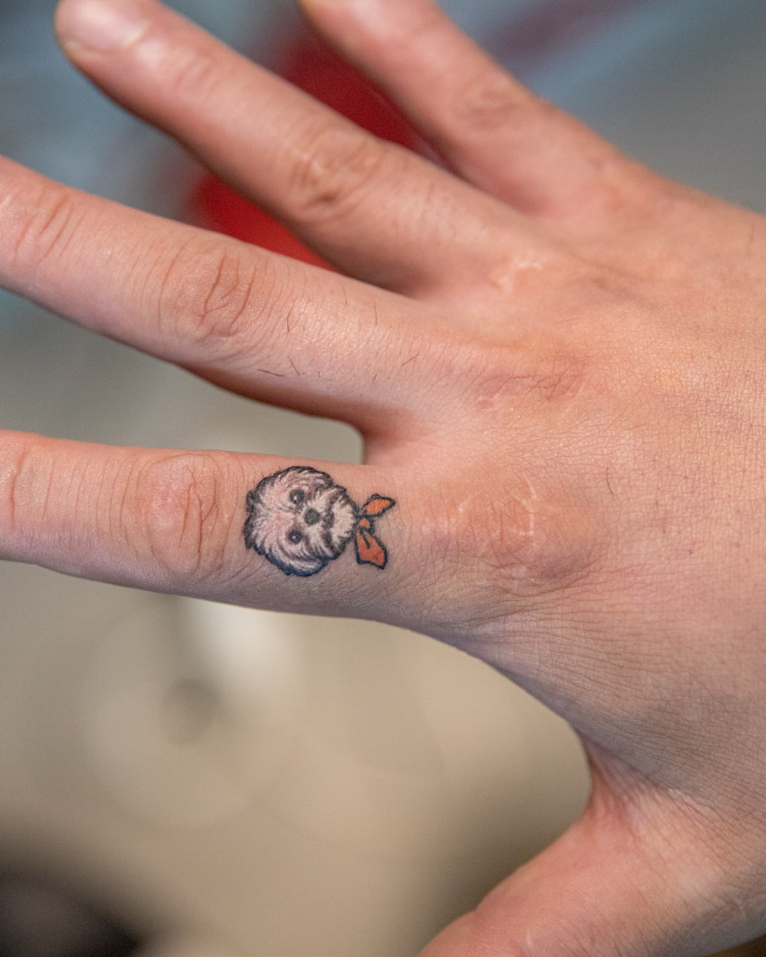 Dog with bandana dotwork tattoo on the hand by 홍대타투