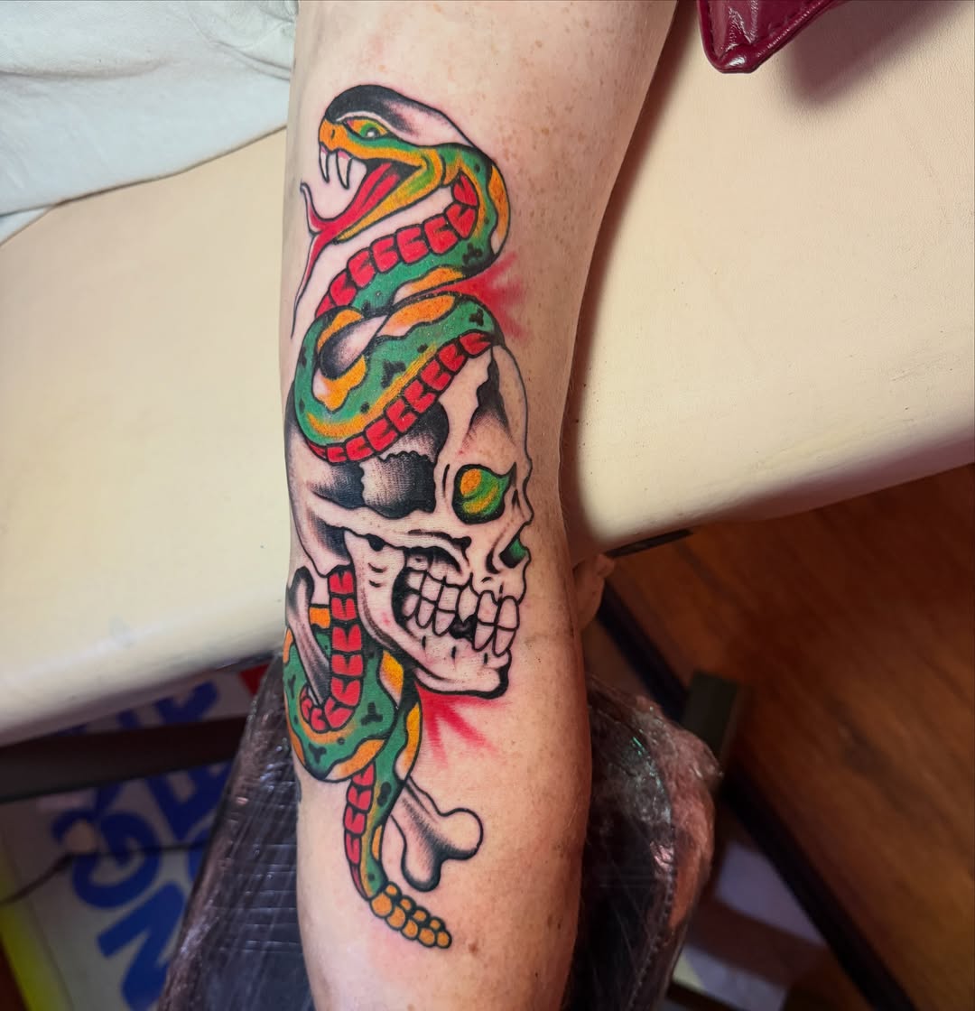 Snake and skull American traditional tattoo on the forearm by Angus Perfect, Philadelphia, Pennsylvania