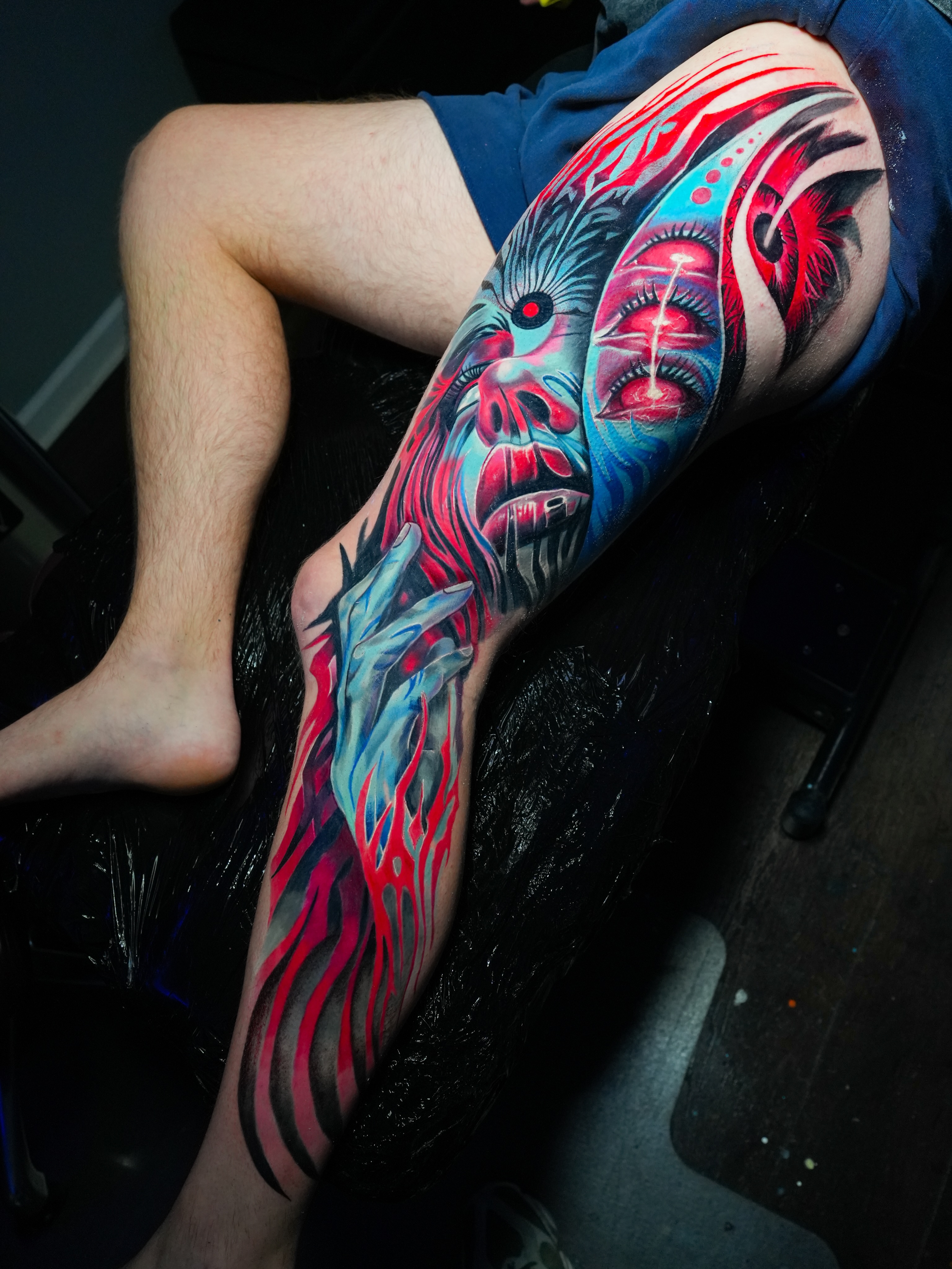 Abstract face dotwork tattoo on the thigh by Devin Mullen