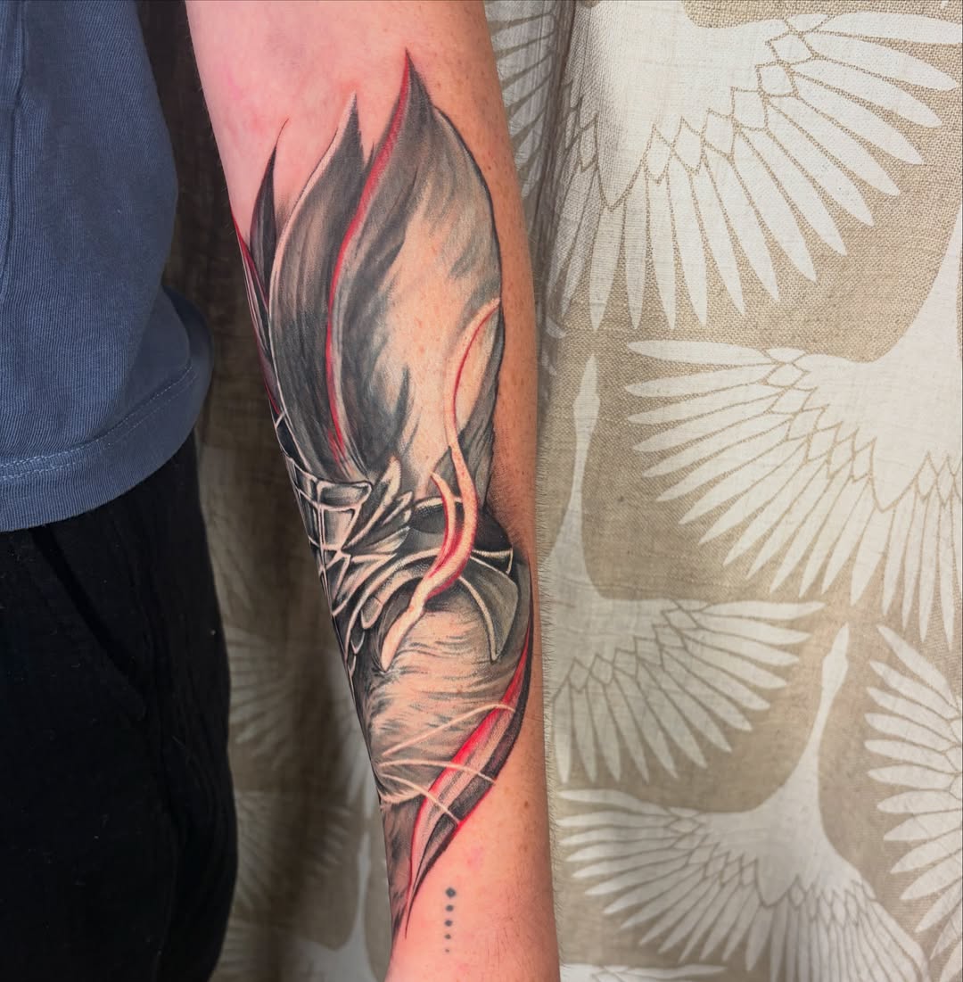 Flame dark realism tattoo on the forearm by Eva Williams
