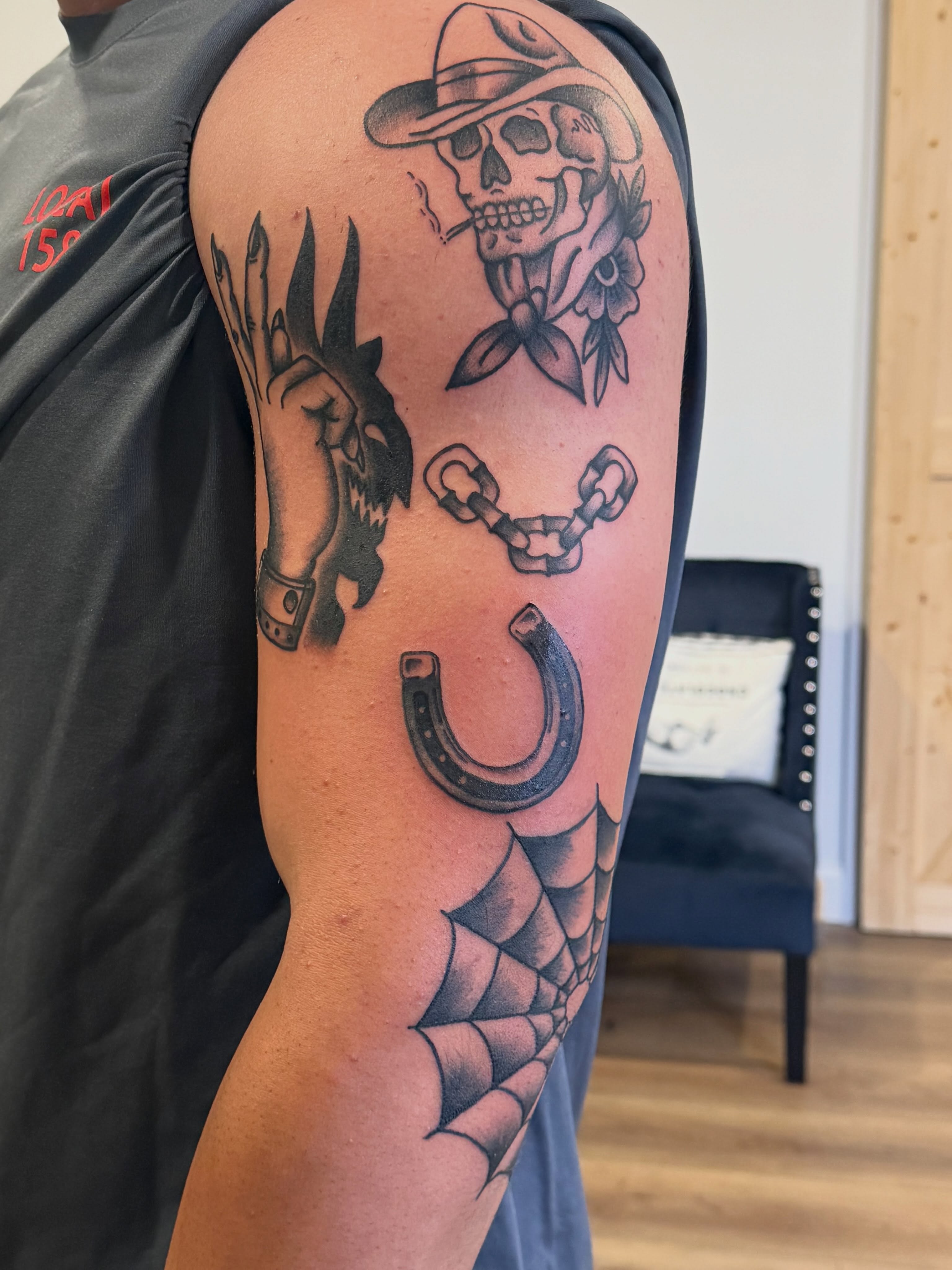 Skull with hat and chain American traditional tattoo on the forearm by Krystal Harris