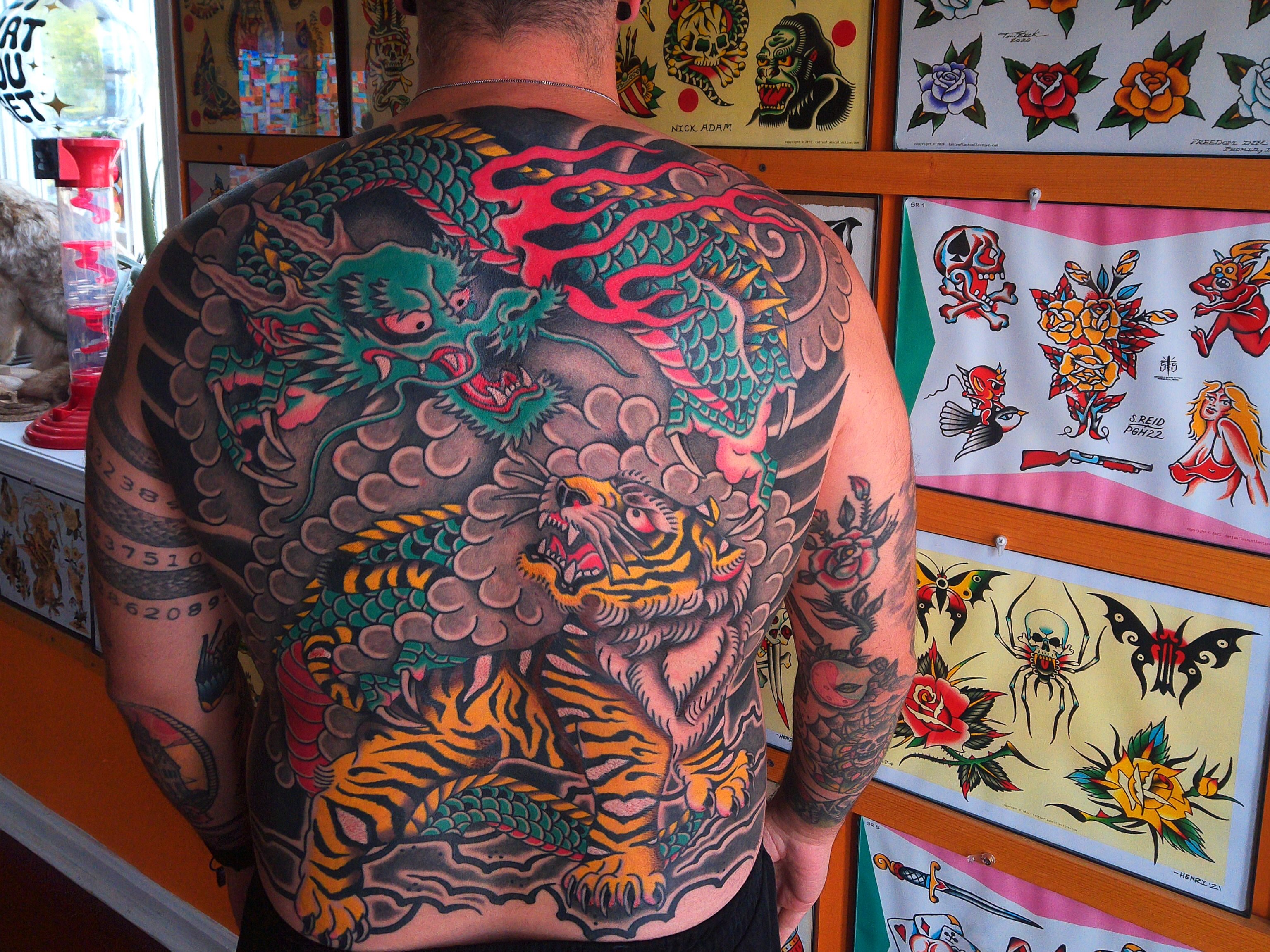 Tiger and dragon American traditional tattoo on the back by ༺tessa༻