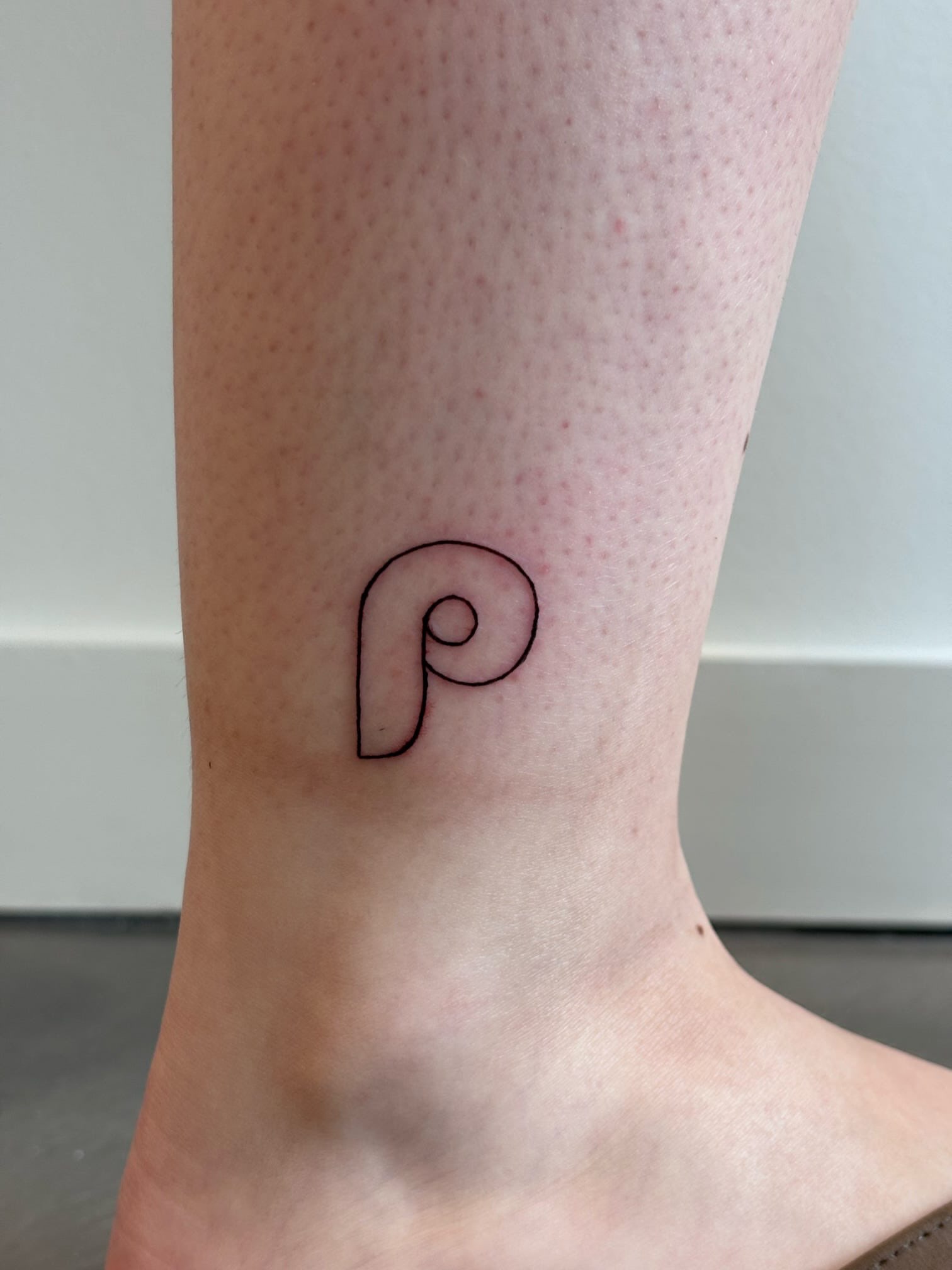 Letter p fine line tattoo on the foot by Malissa