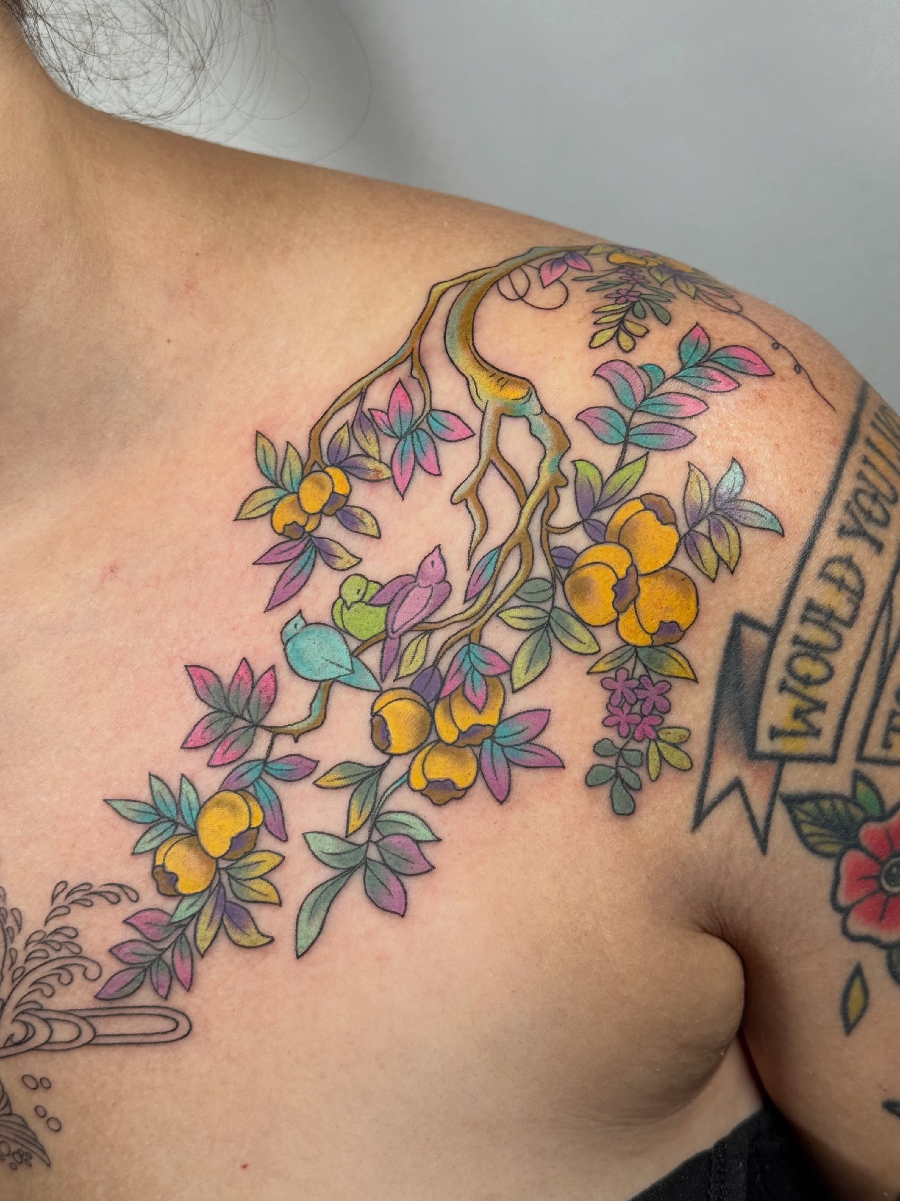 Branch with flowers and birds new school tattoo on the shoulder by Larkin Resler