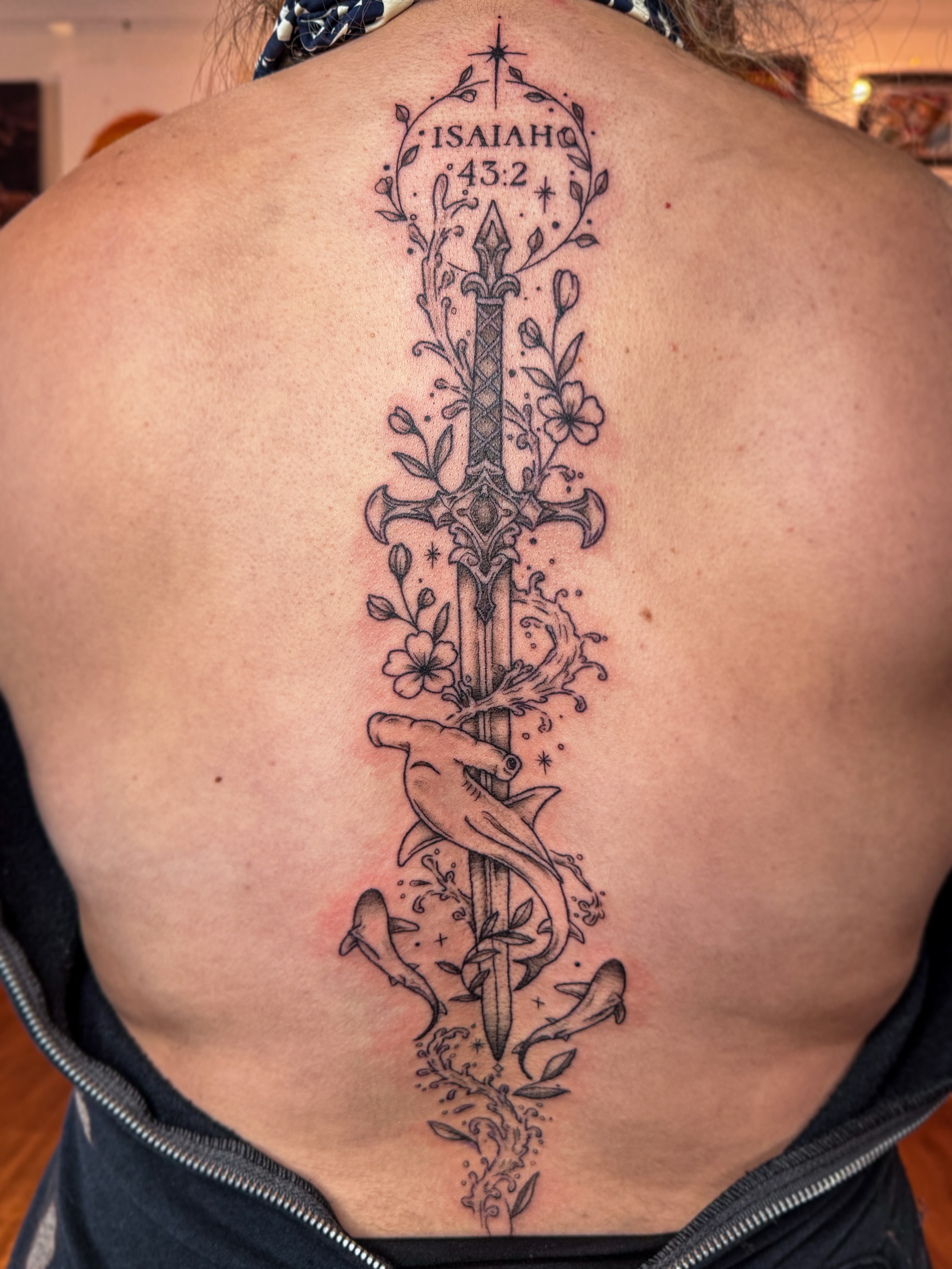 Sword and dolphins black and grey tattoo on the back by Ash✨