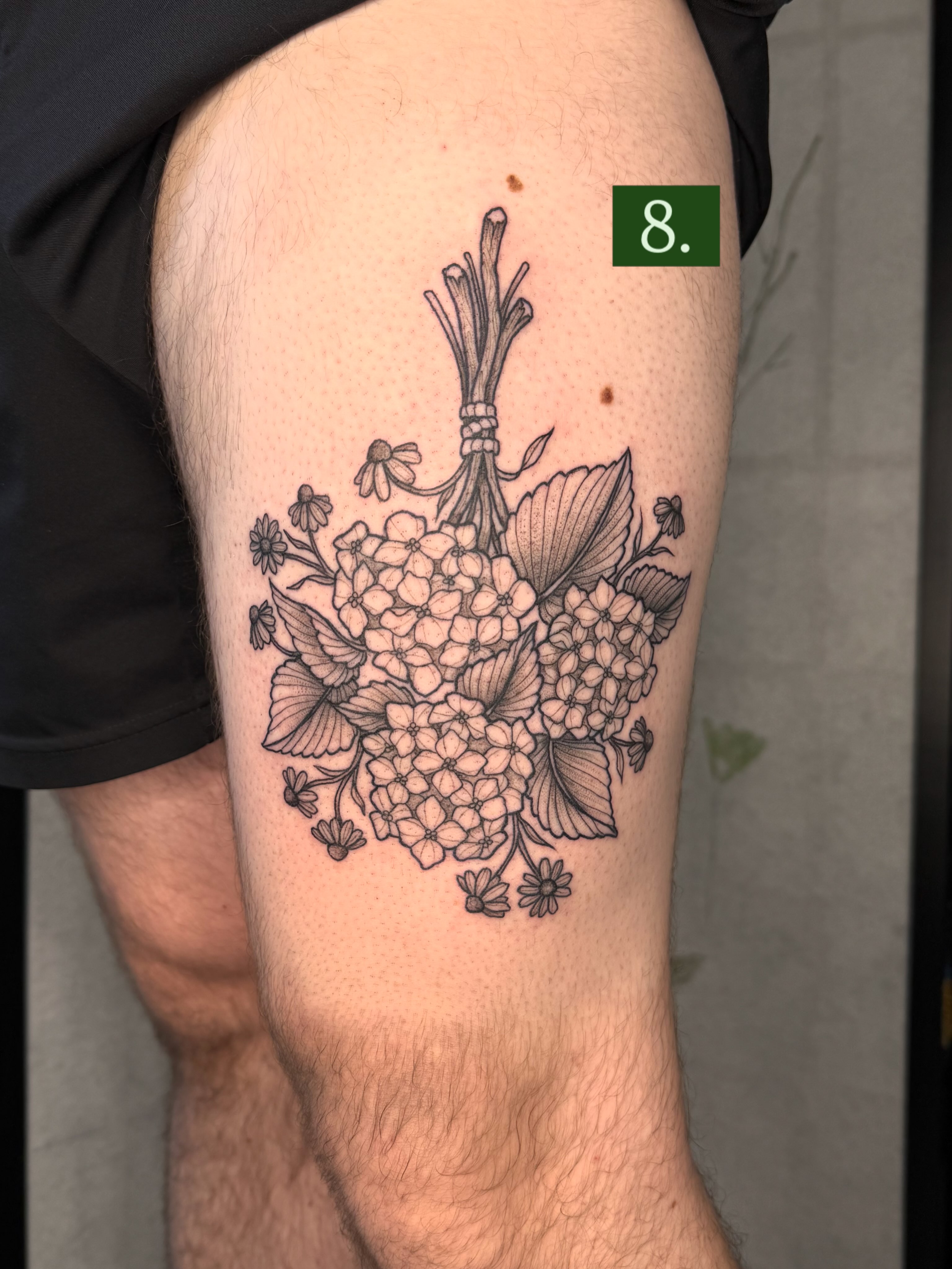 Hydrangea bouquet black and grey tattoo on the thigh by Noelle Adrienne Tattoos