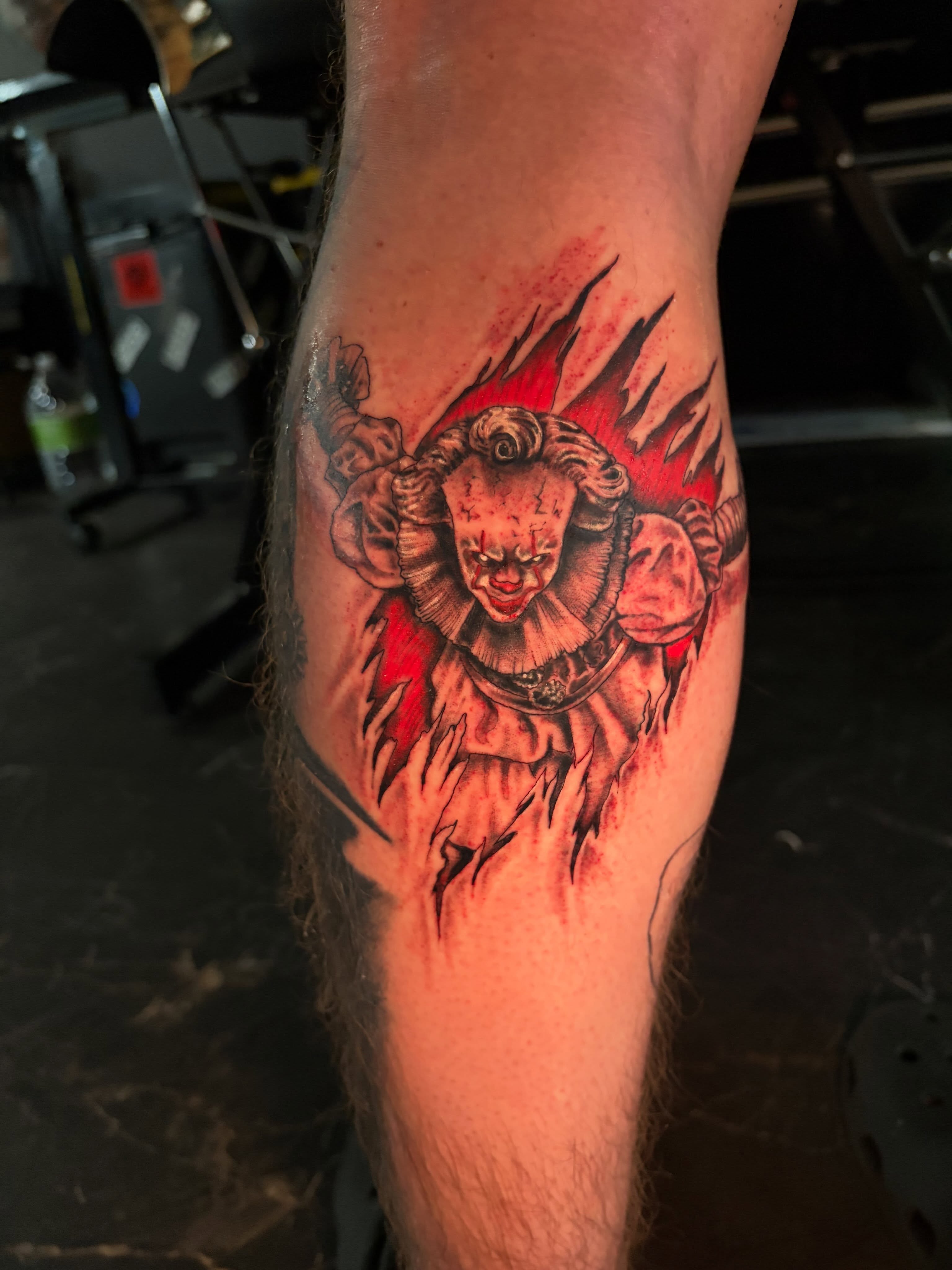 Clown with ram horns dark realism tattoo on the forearm by Fredrick Tigerman