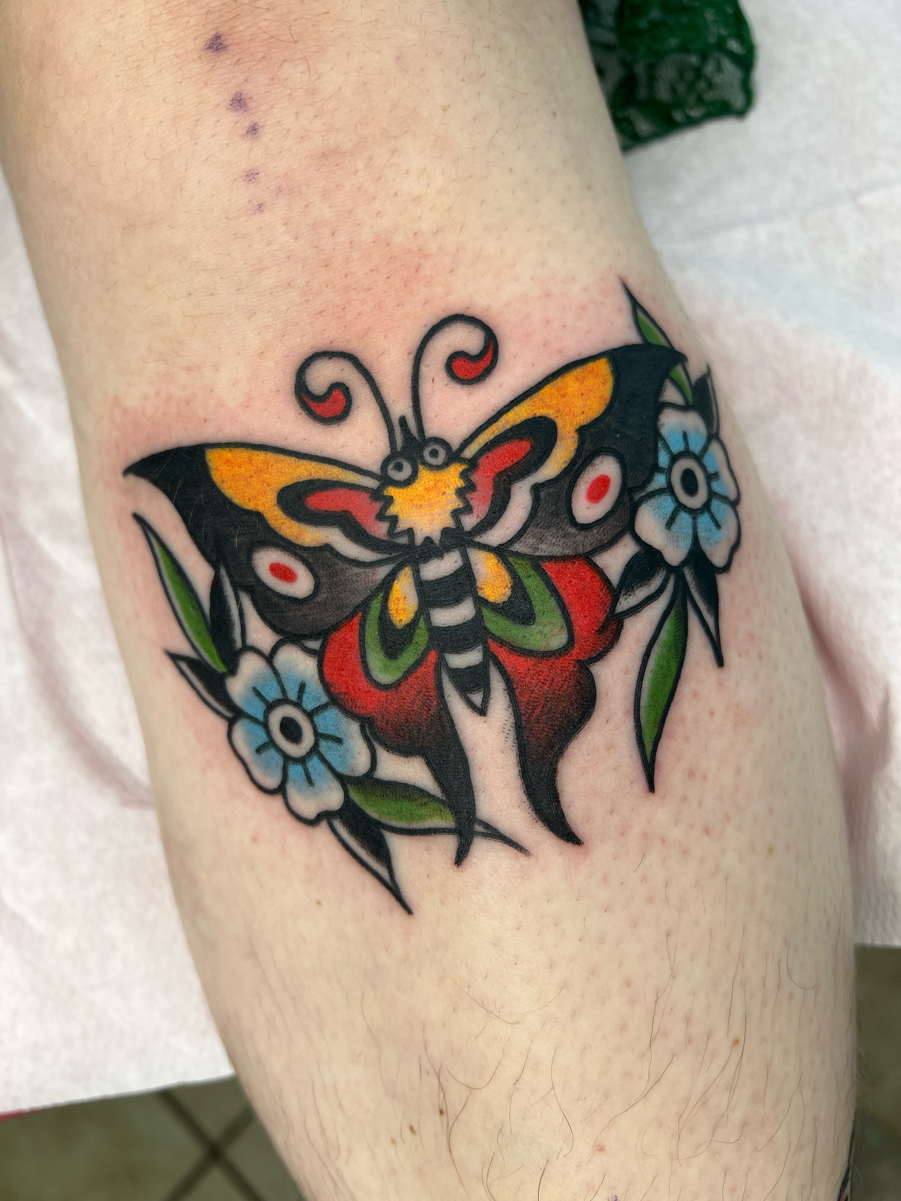 Butterfly and flowers American traditional tattoo on the forearm by Leo 🌞 Pdx Tattoo