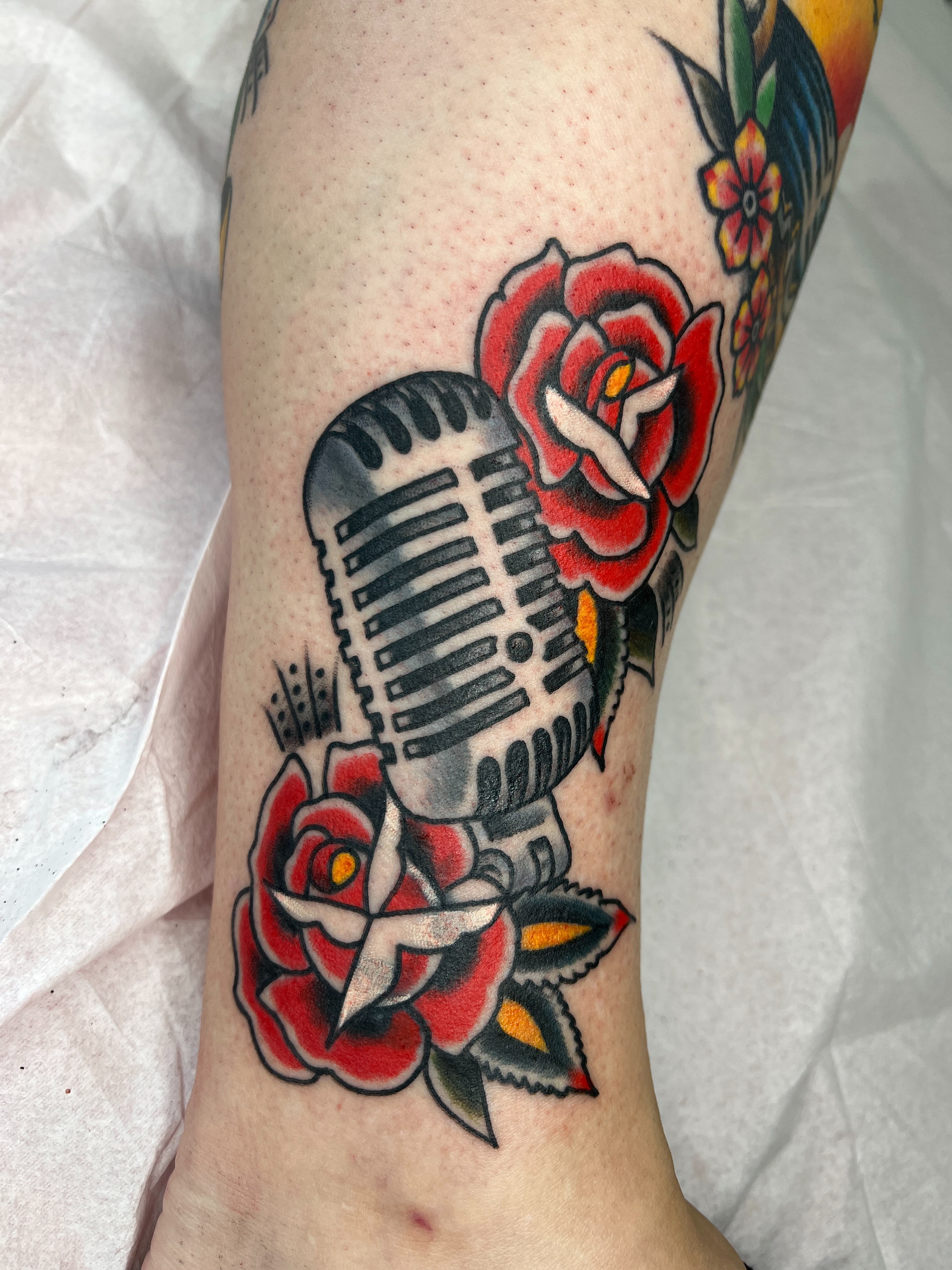 Microphone and roses American traditional tattoo on the forearm by Leo 🌞 Pdx Tattoo