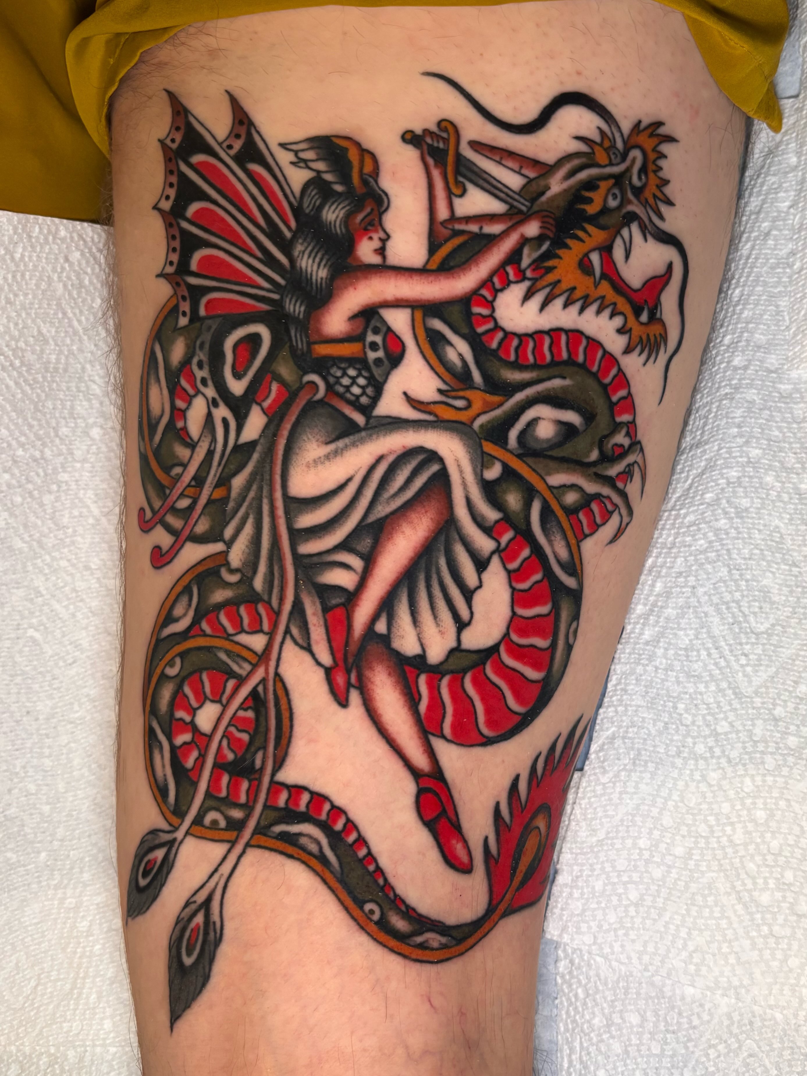 Mythical creature and dragon American traditional tattoo on the thigh by Jesse Smith, Chicago, Illinois
