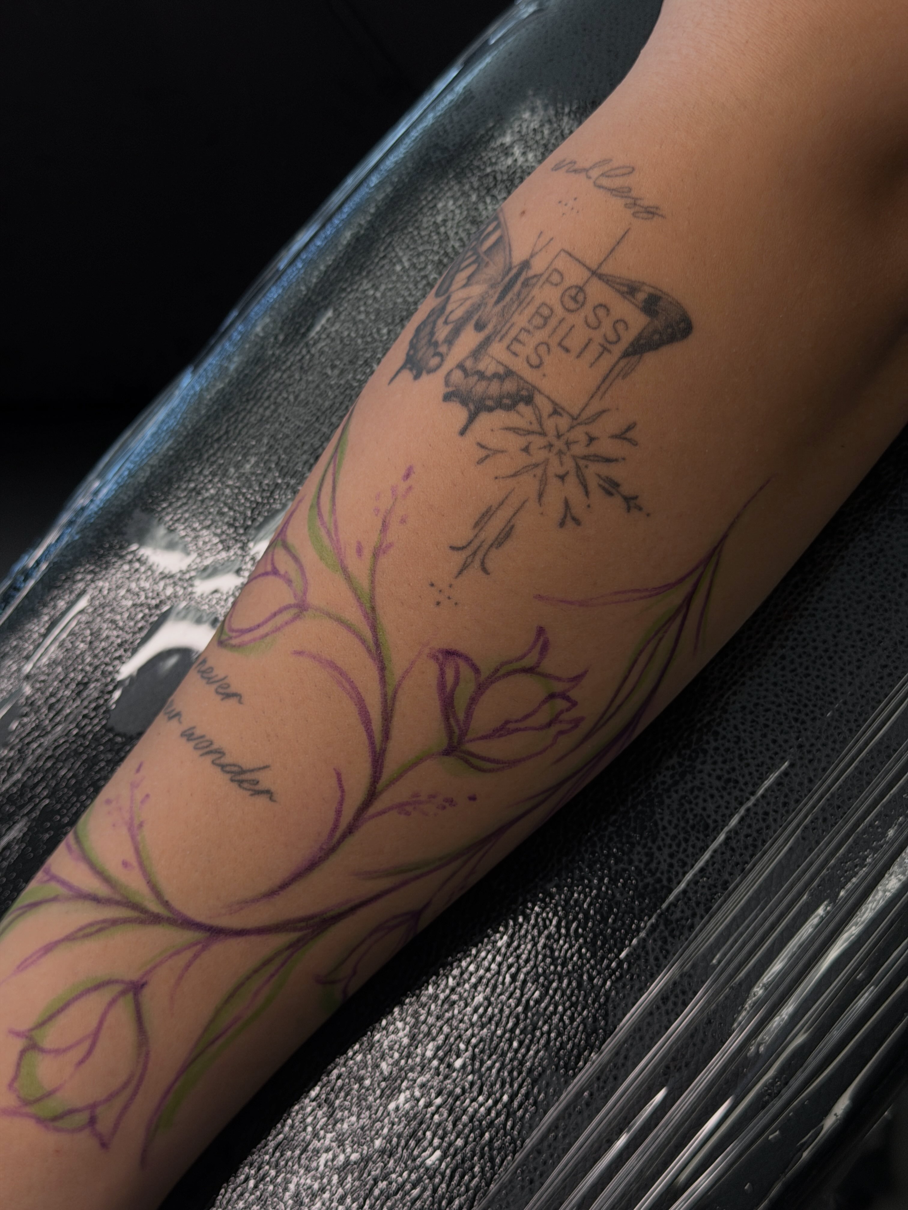 Floral design fine line tattoo on the forearm by Hannah Matthews