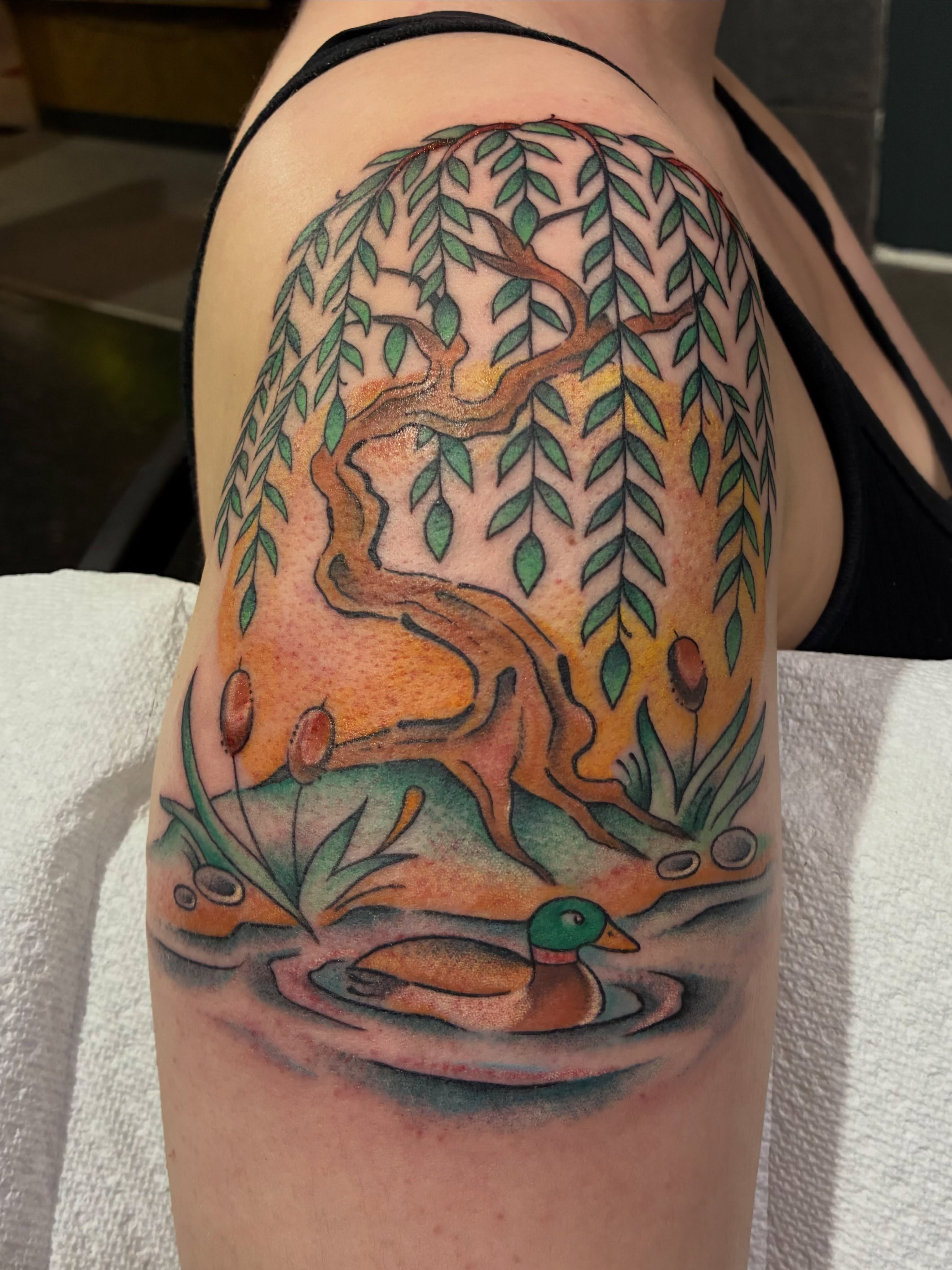 Duck and willow tree realism tattoo on the upper arm by Natalie Spuhler