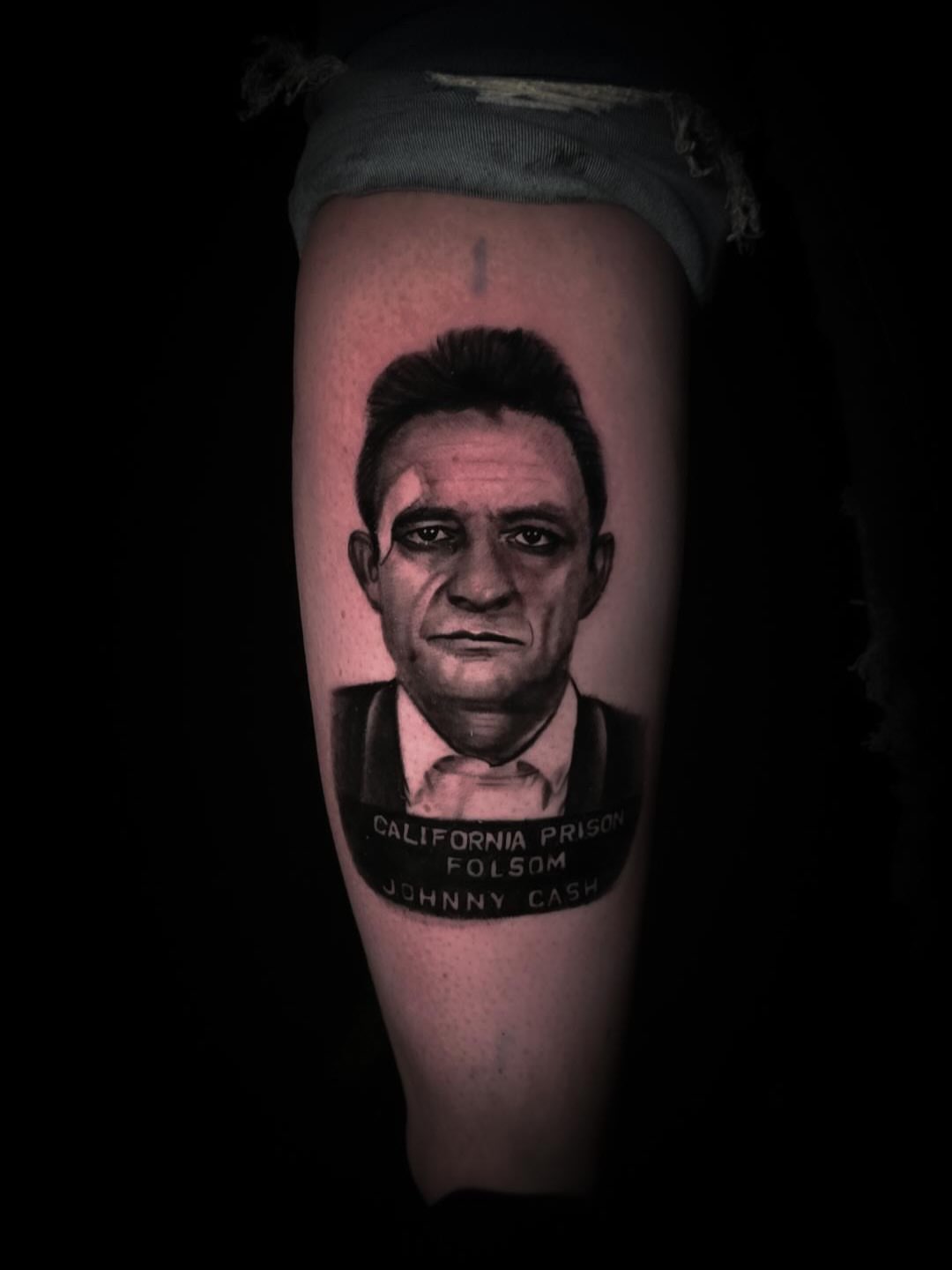 Johnny cash mugshot realism tattoo on the forearm by John Christo Blake