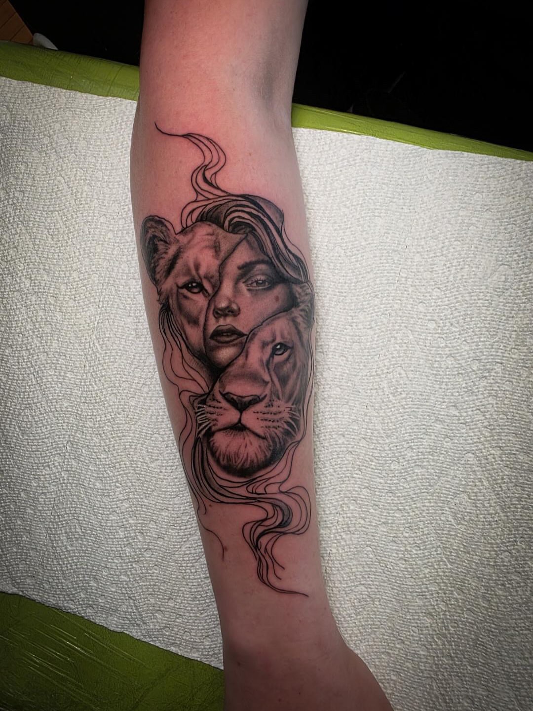 Lion and woman realism tattoo on the forearm by John Christo Blake