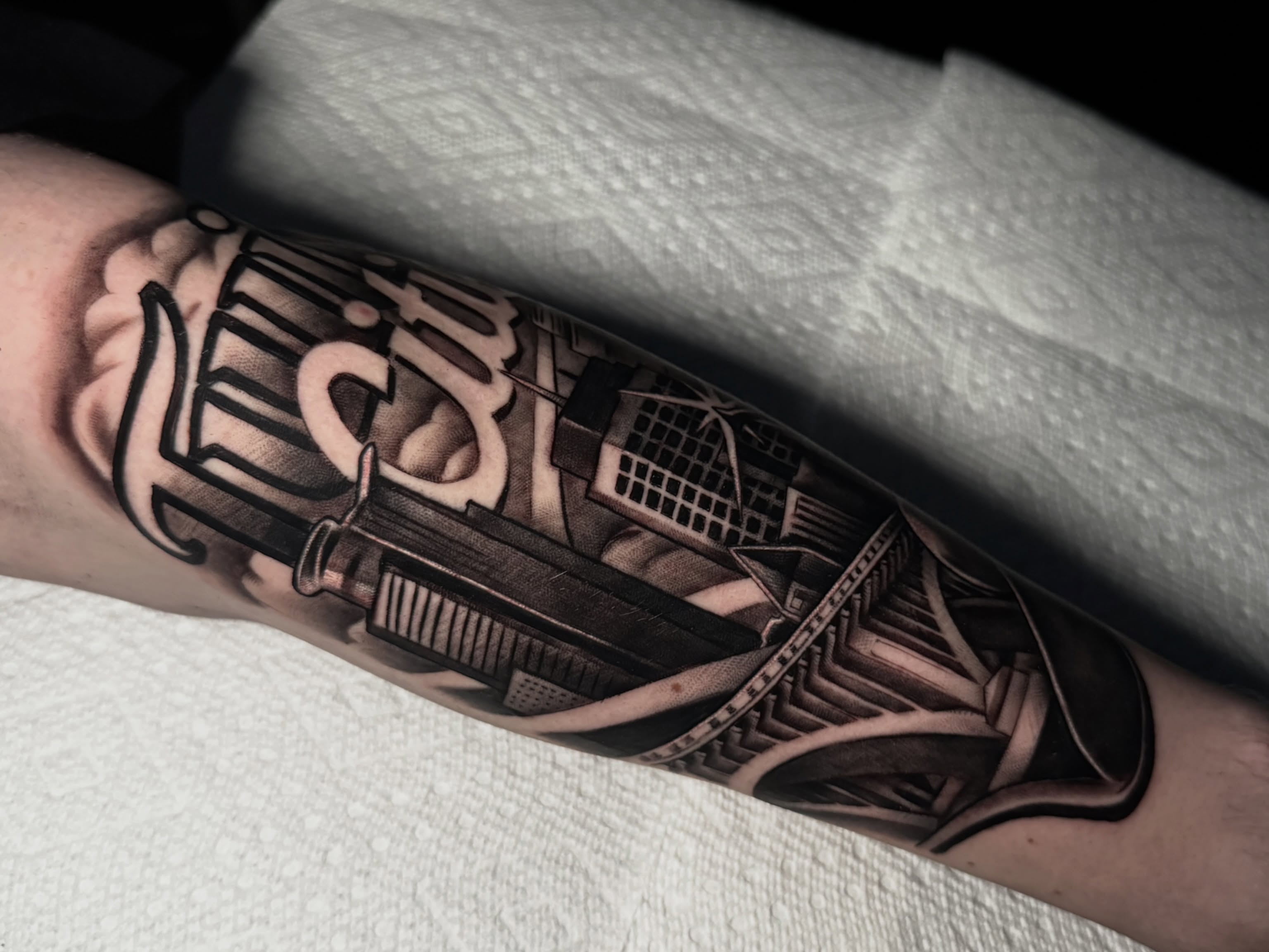 Cityscape geometric tattoo on the forearm by Jaxx Kesler