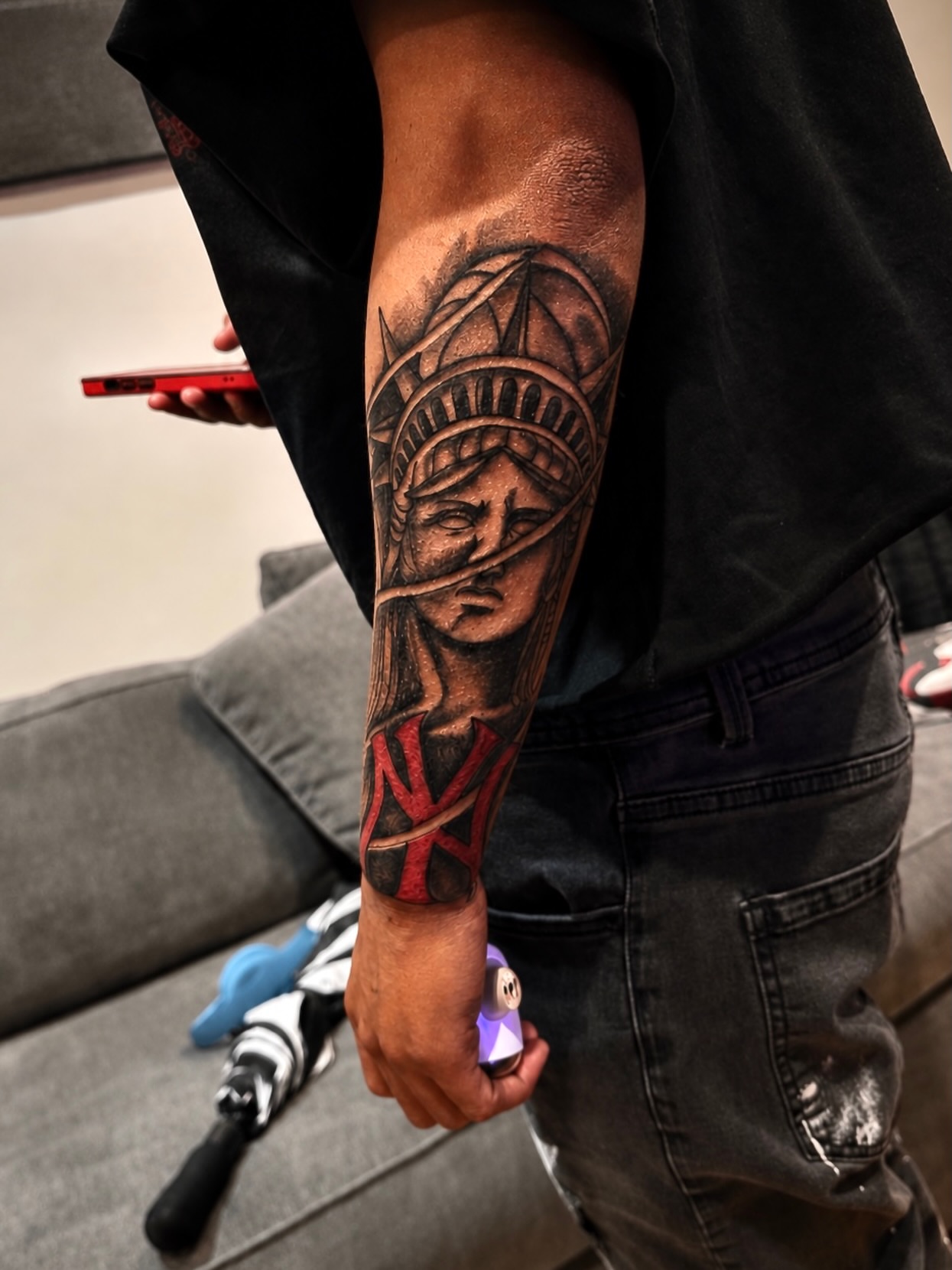 Statue of liberty black and grey tattoo on the forearm by JayyeSosa