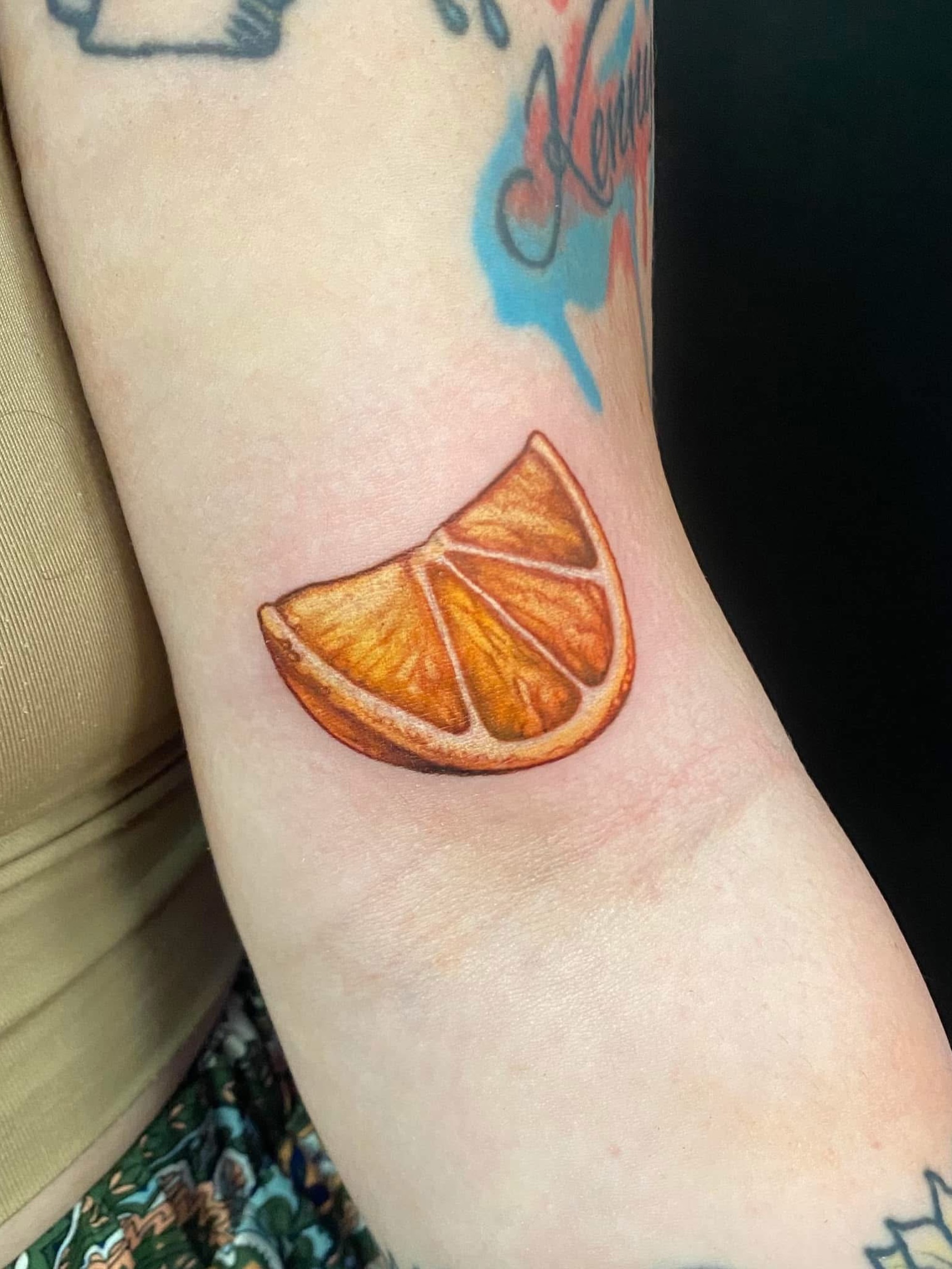 Orange slice realism tattoo on the forearm by ✨Meredith Brewington✨ Maryland Tattoo