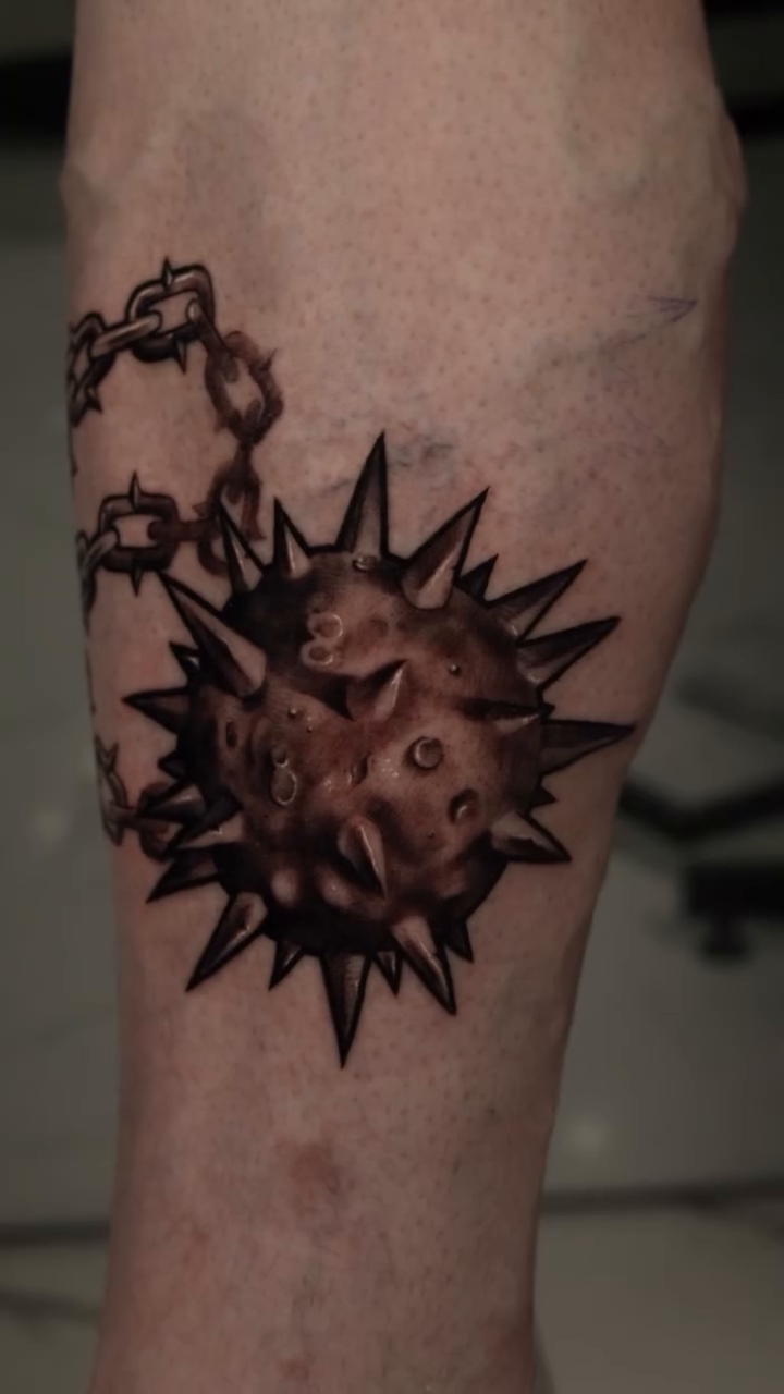 Flail and spiked ball blackwork tattoo by Anthony Maya