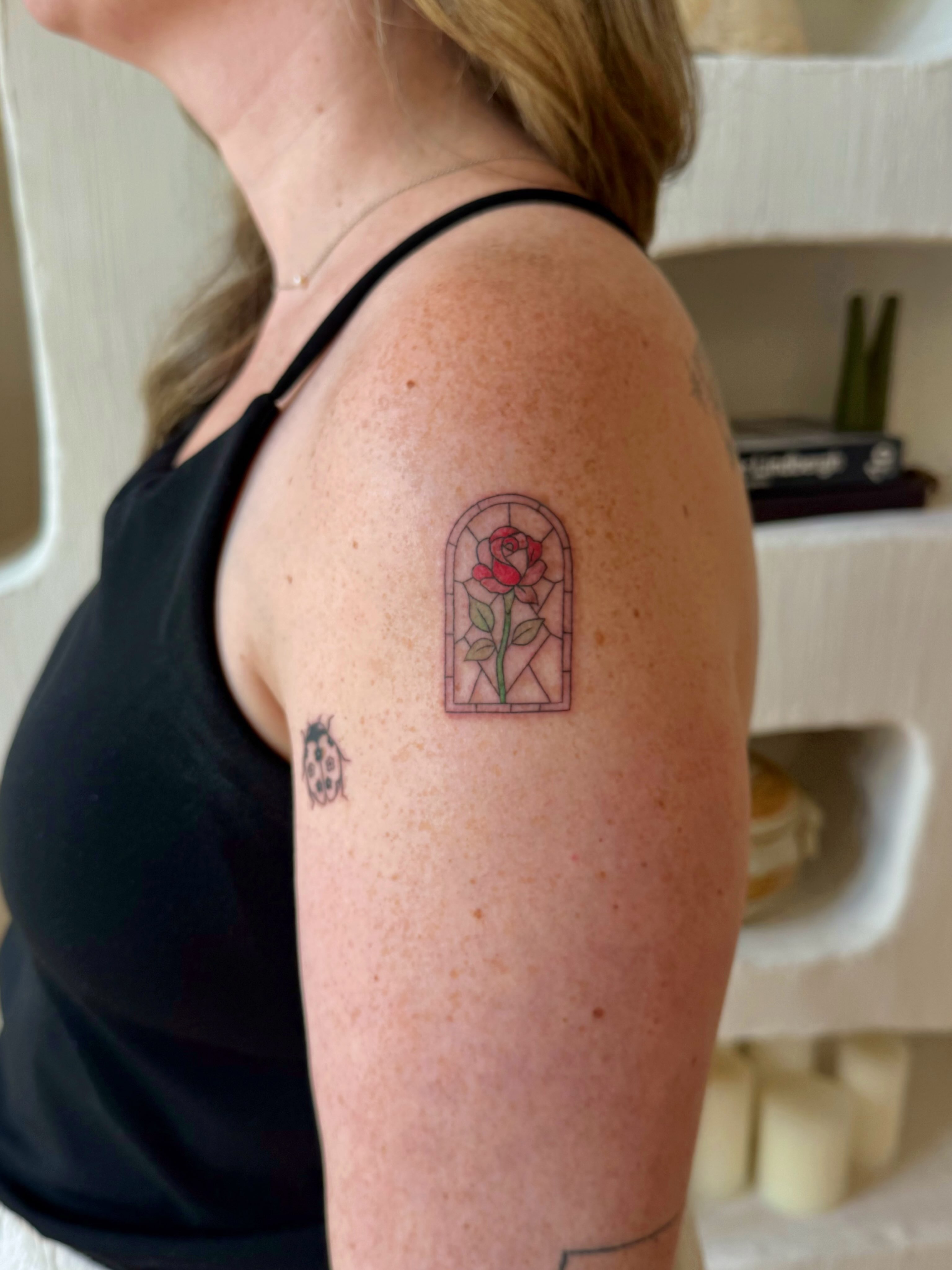 Stained glass window with rose geometric tattoo on the upper arm by Shilo Gold 🍒